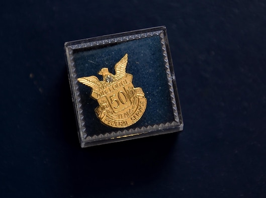 A 50 year pin service pun lays on a table August 13, 2018, on Columbus Air Force Base, Mississippi. (U.S. Air Force photo by Airman 1st Class Keith Holcomb)