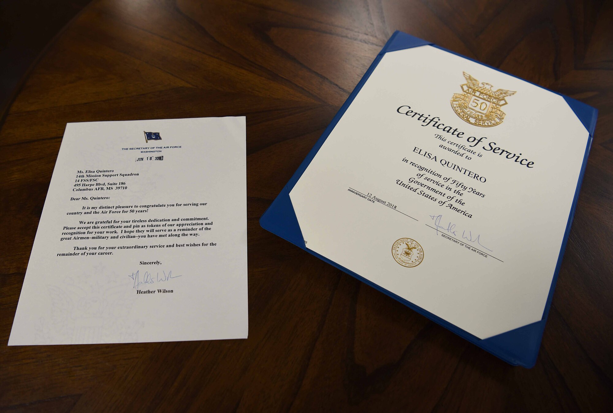 Documents recognizing Elisa Quintero, 14th Force Support Squadron Youth Programs operations clerk, for her service lay on a table August 13, 2018, on Columbus Air Force Base, Mississippi. (U.S. Air Force photo by Airman 1st Class Keith Holcomb)