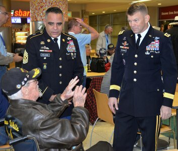 Command Sgt. Maj. Alberto Delgado (left), U.S. Army North (Fifth Army), and Lt. Gen. Jeffrey Buchanan (right), commanding general, ARNORTH, speak with a World War II veteran before the start of a sendoff ceremony at the San Antonio International Airport Oct. 17, which saw 40 WWII veterans take off for a trip to New Orleans to visit the National World War II Museum. The Soaring Valor program, sponsored by the Gary Sinise Foundation, helped send the veterans and 40 high school Student companions from Dallas, to the museum.