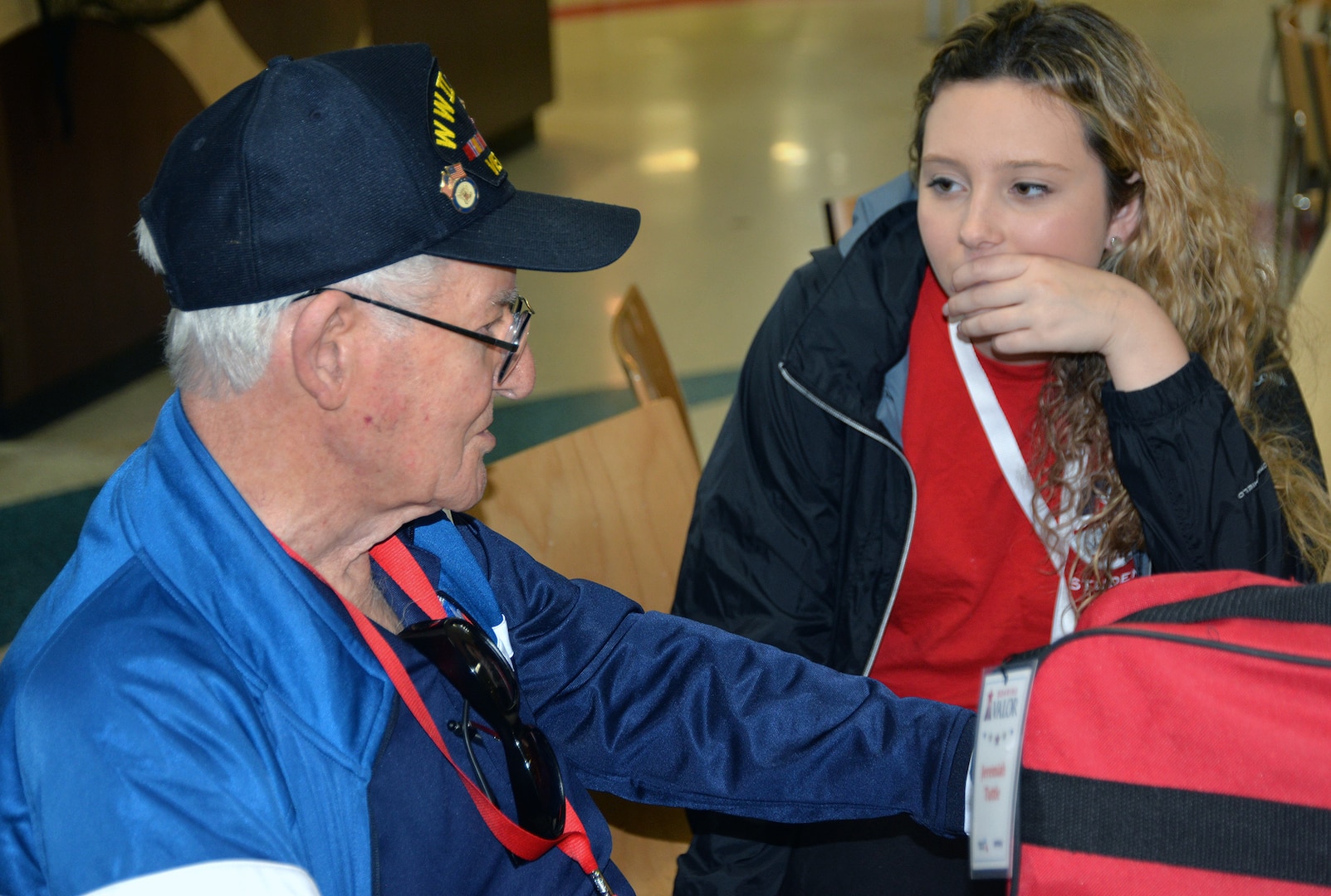 A World War II veteran chats with his designated escort before a sendoff ceremony at the San Antonio International Airport Oct. 17, which saw 40 WWII veterans take off for a trip to New Orleans to visit the National World War II Museum. The Soaring Valor program, sponsored by the Gary Sinise Foundation, helped send the veterans and 40 high school Student companions from Dallas, to the museum.