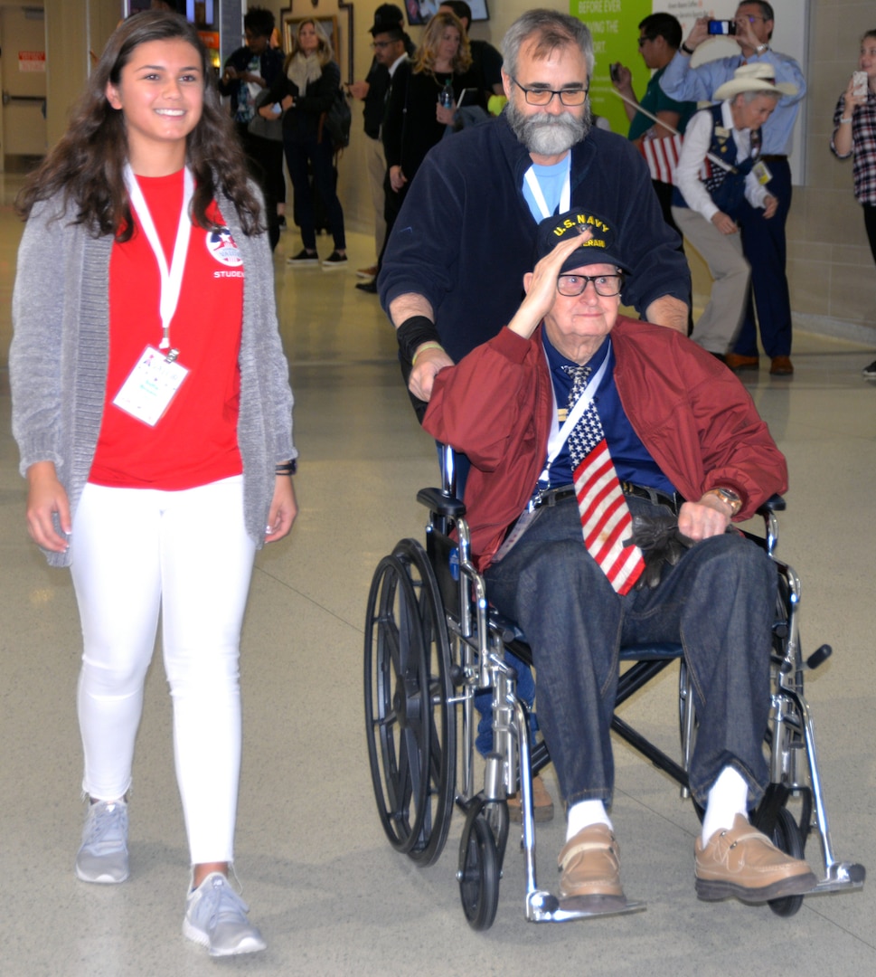 A World War II veteran salutes at the start of a sendoff ceremony at the San Antonio International Airport Oct. 17, which saw 40 WWII veterans take off for a trip to New Orleans to visit the National World War II Museum. The Soaring Valor program, sponsored by the Gary Sinise Foundation, helped send the veterans and 40 high school Student companions from Dallas, to the museum.