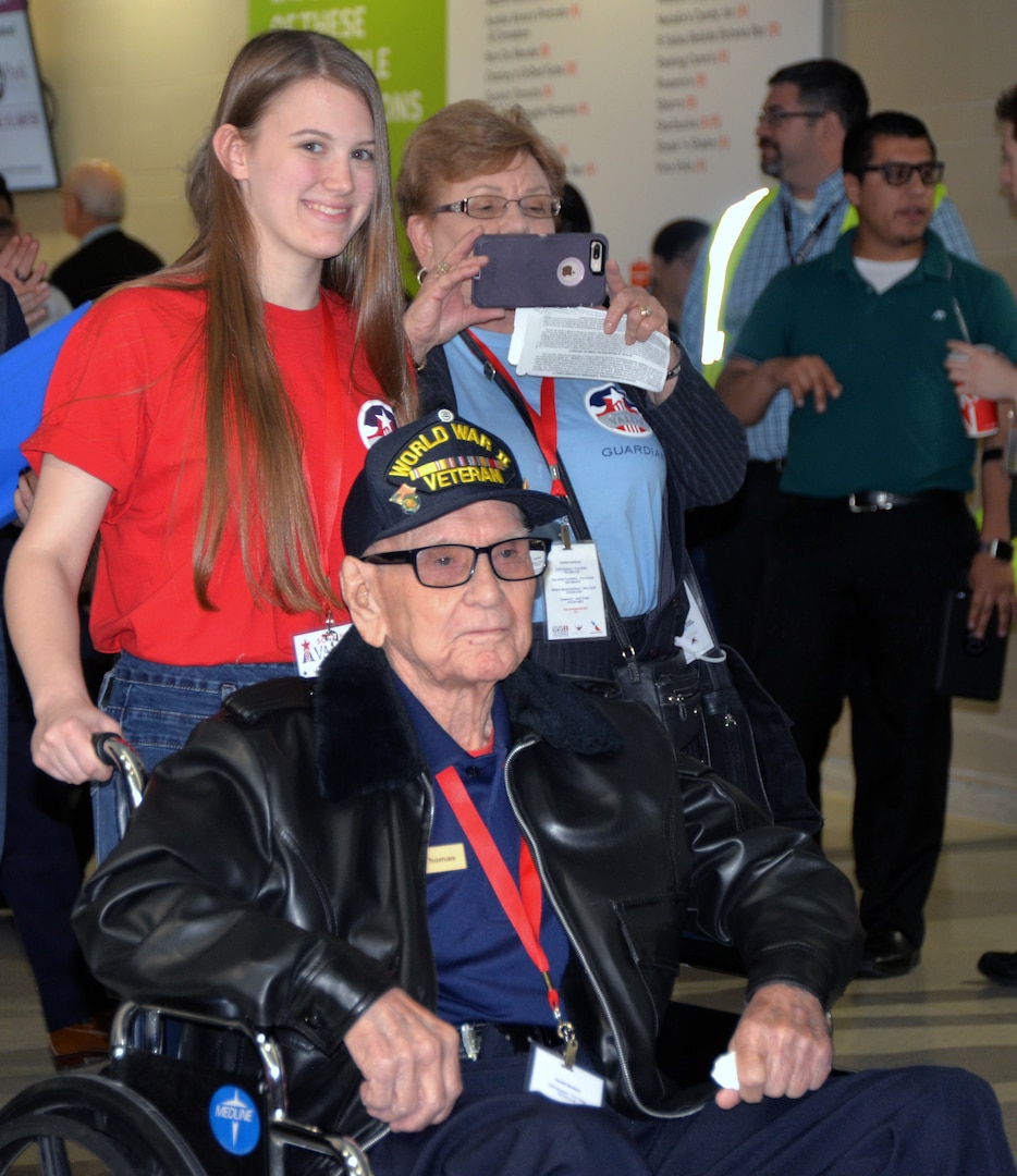 A World War II veteran, along with his high school escort, enjoy the reception as they arrive for a sendoff ceremony at the San Antonio International Airport Oct. 17, which saw 40 WWII veterans take off for a trip to New Orleans to visit the National World War II Museum. The Soaring Valor program, sponsored by the Gary Sinise Foundation, helped send the veterans and 40 high school Student companions from Dallas, to the museum.
