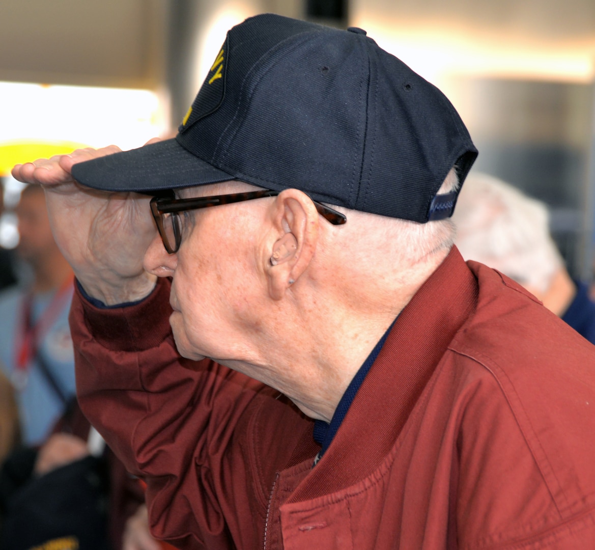 A World War II veteran renders a salute during the singing of the National Anthem at the conclusion of a sendoff ceremony at the San Antonio International Airport Oct. 17 which saw 40 WWII veterans take off for a trip to New Orleans to visit the National World War II Museum. The Soaring Valor program, sponsored by the Gary Sinise Foundation, helped send the veterans and 40 high school Student companions from Dallas, to the museum.