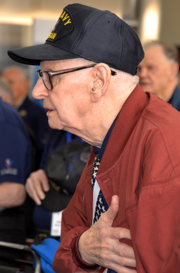 A World War II veteran holds his hand over his heart during the Pledge of Allegiance at the conclusion of a sendoff ceremony at the San Antonio International Airport Oct. 17 which saw 40 WWII veterans take off for a trip to New Orleans to visit the National World War II Museum. The Soaring Valor program, sponsored by the Gary Sinise Foundation, helped send the veterans and 40 high school Student companions from Dallas, to the museum.