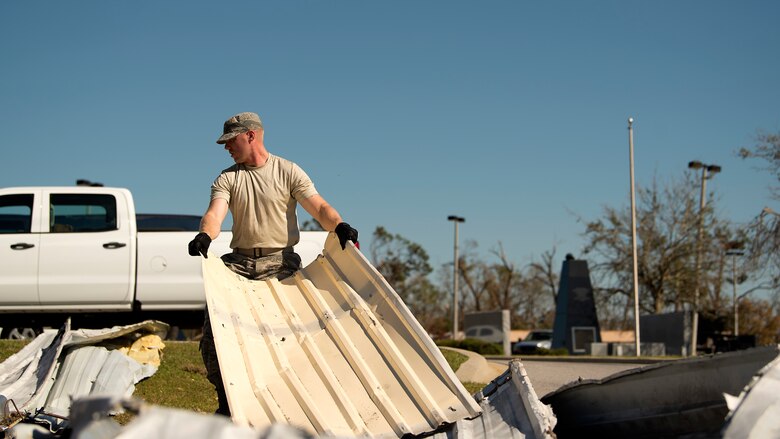 Airman 1st Class Cody Neuweiler, a 290th Joint Communications Support Squadron member from MacDill Air Force Base, Fla., clears rubble obstructing the roadway so his team can establish communications at another location, Oct. 13, 2018. With support from the Joint Communications Support Element of U.S. Transportation Command and MacDill AFB’s 6th Air Mobility Wing Force Support Squadron, this team was one of the first on scene, clearing their own path to support the Bay County emergency operations center and enable recovery efforts in Panama City, Fla. (U.S. Air Force photo by Airman 1st Class Caleb Nunez)