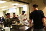 Florida National Guard Soldiers from the 53rd Brigade Support Battalion in Pinellas Park, Florida, serve themselves food provided by the World Central Kitchen, Oct. 14, 2018, in Panama City, Florida. The WCK is providing meals in response to Hurricane Michael to Guardsmen, first responders and those who were affected by the natural disaster.