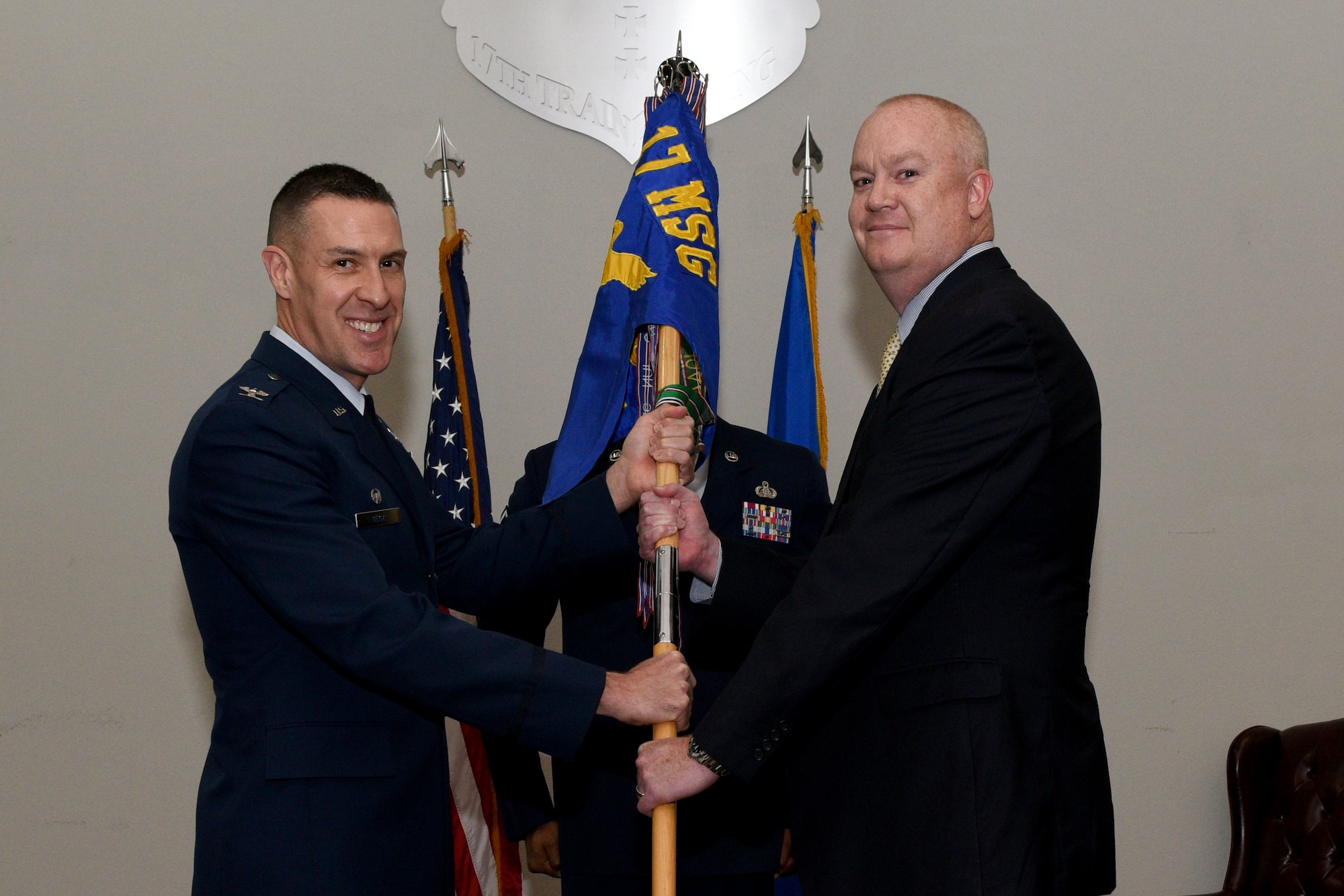 U.S. Air Force Col. Jason Beck, 17th Mission Support Group commander, gives the guideon to 17th Force Support Squadron incoming Director William Dowell, during the 17th FSS assumption of leadership at the Event Center on Goodfellow Air Force Base, Texas, October 19, 2018. The assumption of leadership ceremony is a time honored military tradition that signifies the orderly transfer of authority. (U.S. Air Force photo by Senior Airman Randall Moose/Released)
