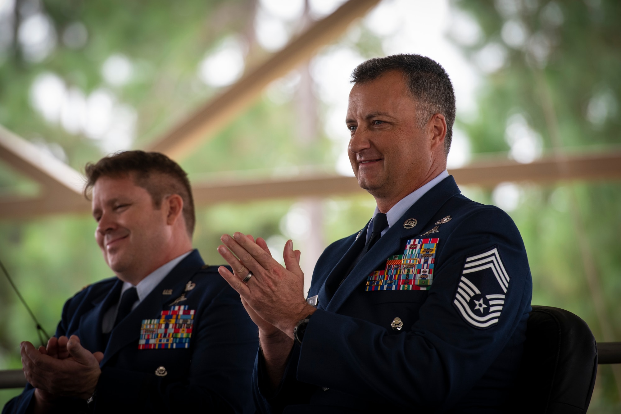 Chief Master Sgt. Michael West, right, a special tactics combat controller with the 24th Special Operations Wing, applauds during his retirement ceremony at Hurlburt Field, Florida, Oct. 19, 2018.
