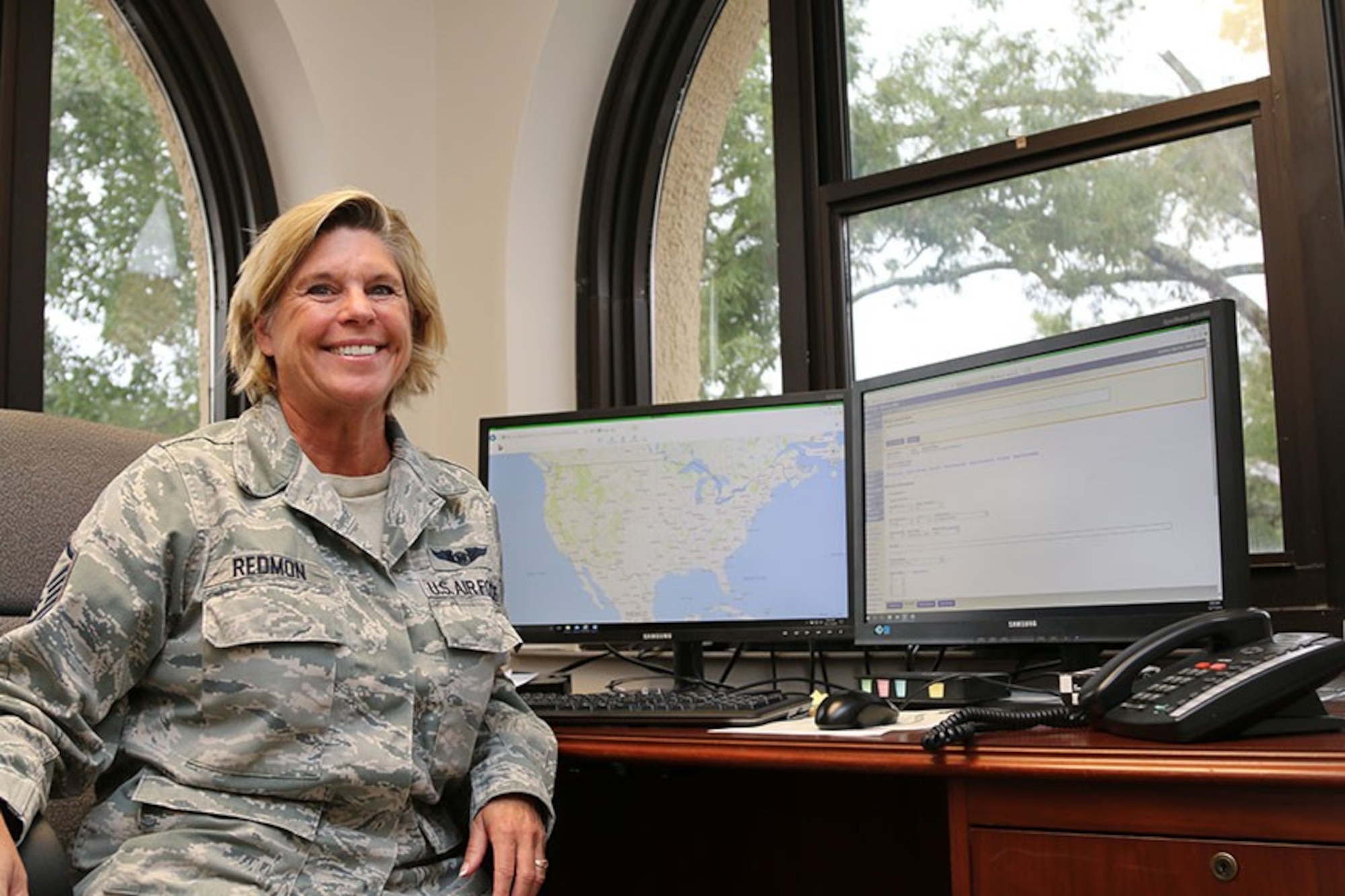 Master Sgt. Kristen Redmon, a Tyndall Air Force Base civilian reservist, works in a temporary office at Maxwell Air Force Base overlooking the National Operations Center at Civil Air Patrol National Headquarters. Redmon relocated to Maxwell AFB, Ala., before Hurricane Michael hit the Tyndall AFB area. (Civil Air Patrol photo by Susan Schneider)