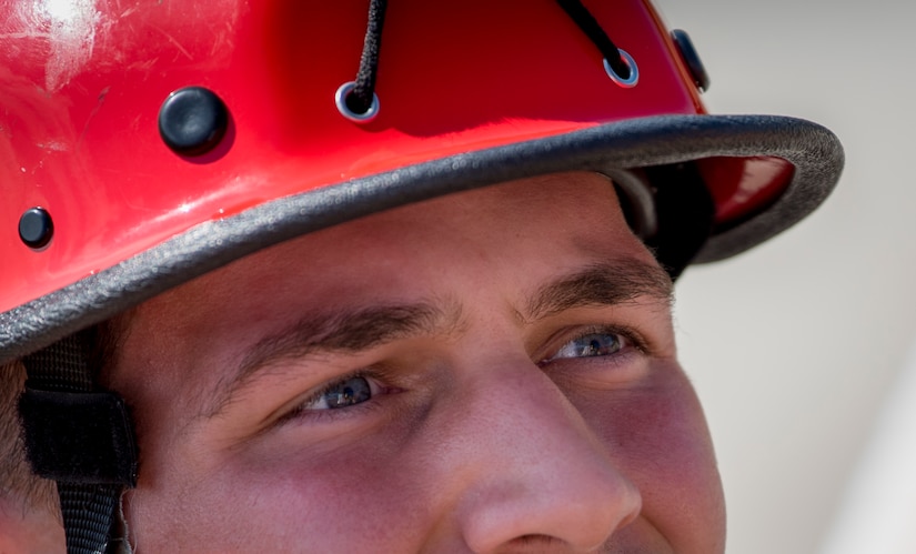 U.S. Air Force Airman 1st Class Brady Mott, 633rd Civil Engineer Squadron firefighter, ascends the side of a building during the final evaluation at Joint Base Langley-Eustis, Virginia, Oct.15, 2018.