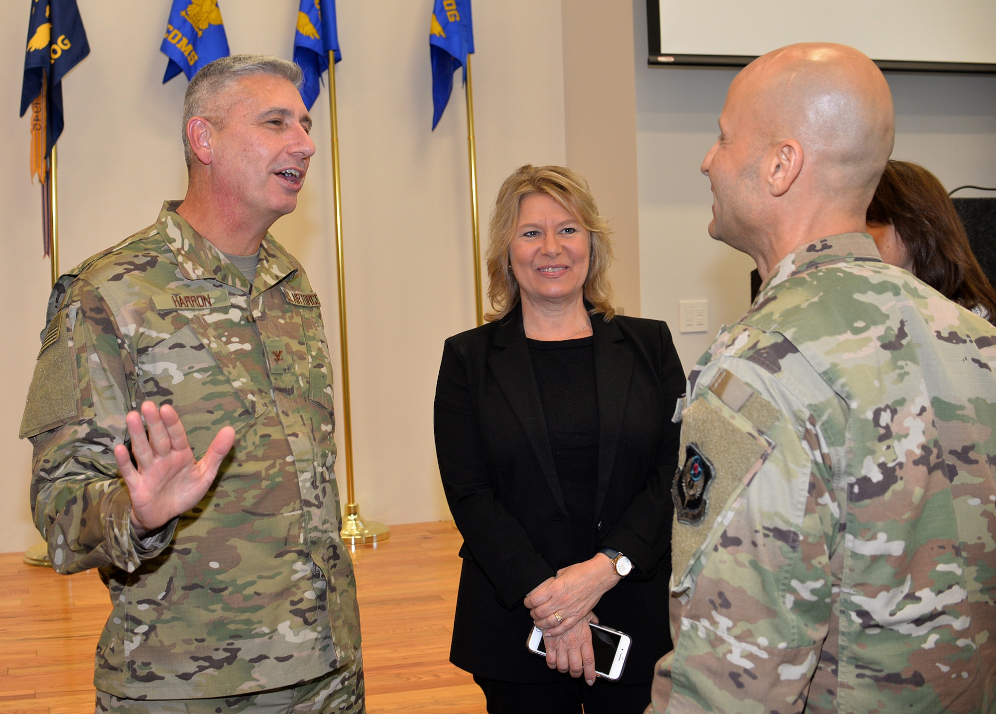 Col. Scott Harron (left), 193rd Air Operations Group commander, and his wife, Kelly, speak to Col. Terrence Koudelka, 193rd Special Operations Wing commander, following Harron's assumption of command ceremony at the AOG Oct. 18. Before taking on the role as AOG commander, Harron served as the 25th Air Force Inspector General, and as Inspection Team Chief at Air Combat Command headquarters. He also served as commander of the 152nd Air Intelligence Squadron at Hancock Field Air National Guard Base, Mattydale, N.Y. Harron spent 16 years as an enlisted troop before commissioning as an Air Force intelligence officer in September 2000. "Scott is the absolute perfect person for this position. His intel experience and track record of deployments is nothing short of impressive," Koudelka said. (U.S. Air National Guard photo by 1st Lt. Susan Penning/Released)