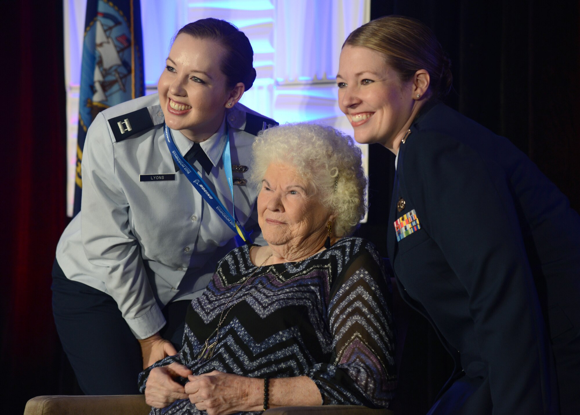 Capt. Rachel Lyons, left, and Capt. Angela Petersen, both from Scott Air Force Base, Illinois, pose with June Buckley, an original Rosie the Riveter, who worked on C-47 Skytrains in the 1940's. Buckley spoke to attendees at the Logistics Officer Association Symposium Oct. 10 about women's defense contributions through history.