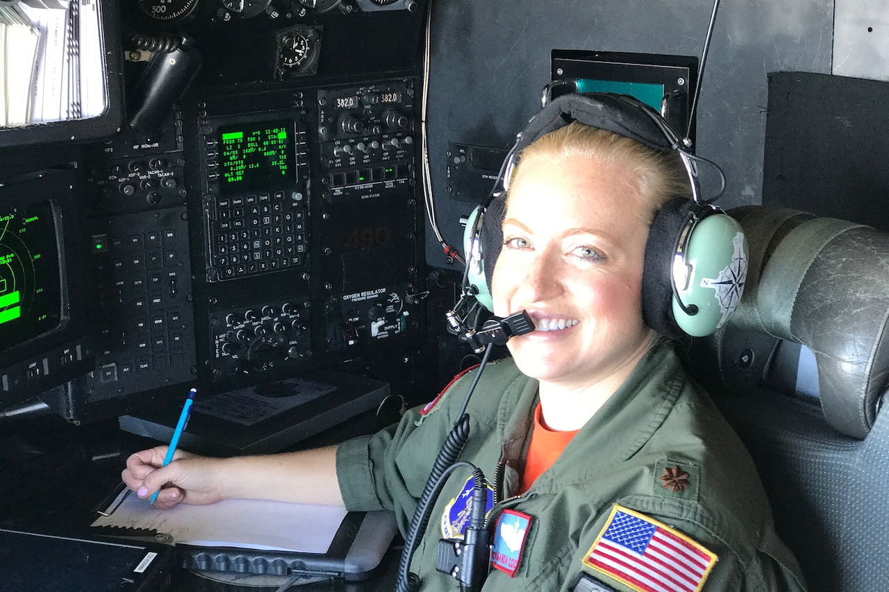 Air Force navigator works inside plane.