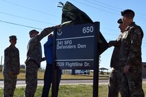 Col. Peter Bonetti, 341st Missile Wing vice commander; Col. Aaron Guill, 341st Security Forces Group commander; Chief Master Sgt. Eryn McElroy, 341st MW command chief; Master Sgt. Jason Seibel, 341st SFG training and scheduling superintendent, assembled in front of the Defenders Den, Oct. 17, 2018, at Malmstrom Air Force Base, Mont. The group officially opened the new 341st SFG building and heritage center. (U.S. Air Force photo by Kiersten McCutchan)