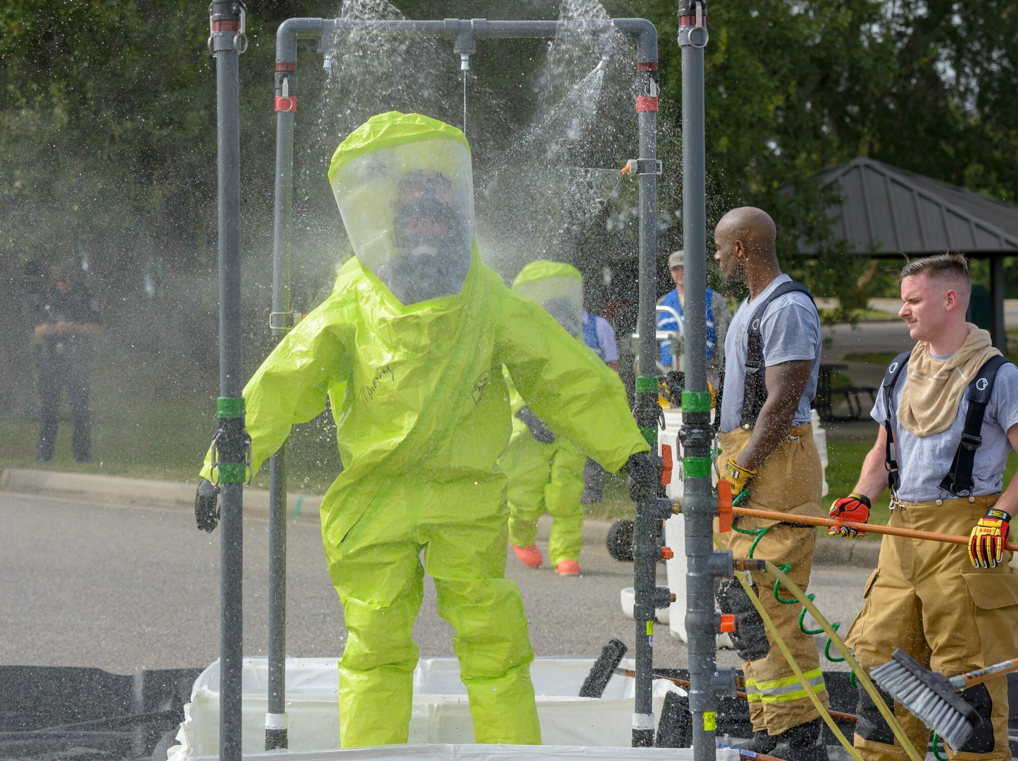 Keesler firefighters go through the decontamination site during the Anti-Terrorism, Force Protection Condition and Chemical, Biological, Radiological, Nuclear and high-yield Explosives training exercise at the Marina on Keesler Air Force Base, Mississippi, Oct. 17, 2018. The AT/FPCON/CBRNE exercise was conducted to evaluate the mission readiness and security of Keesler. (U.S. Air Force photo by Andre' Askew)