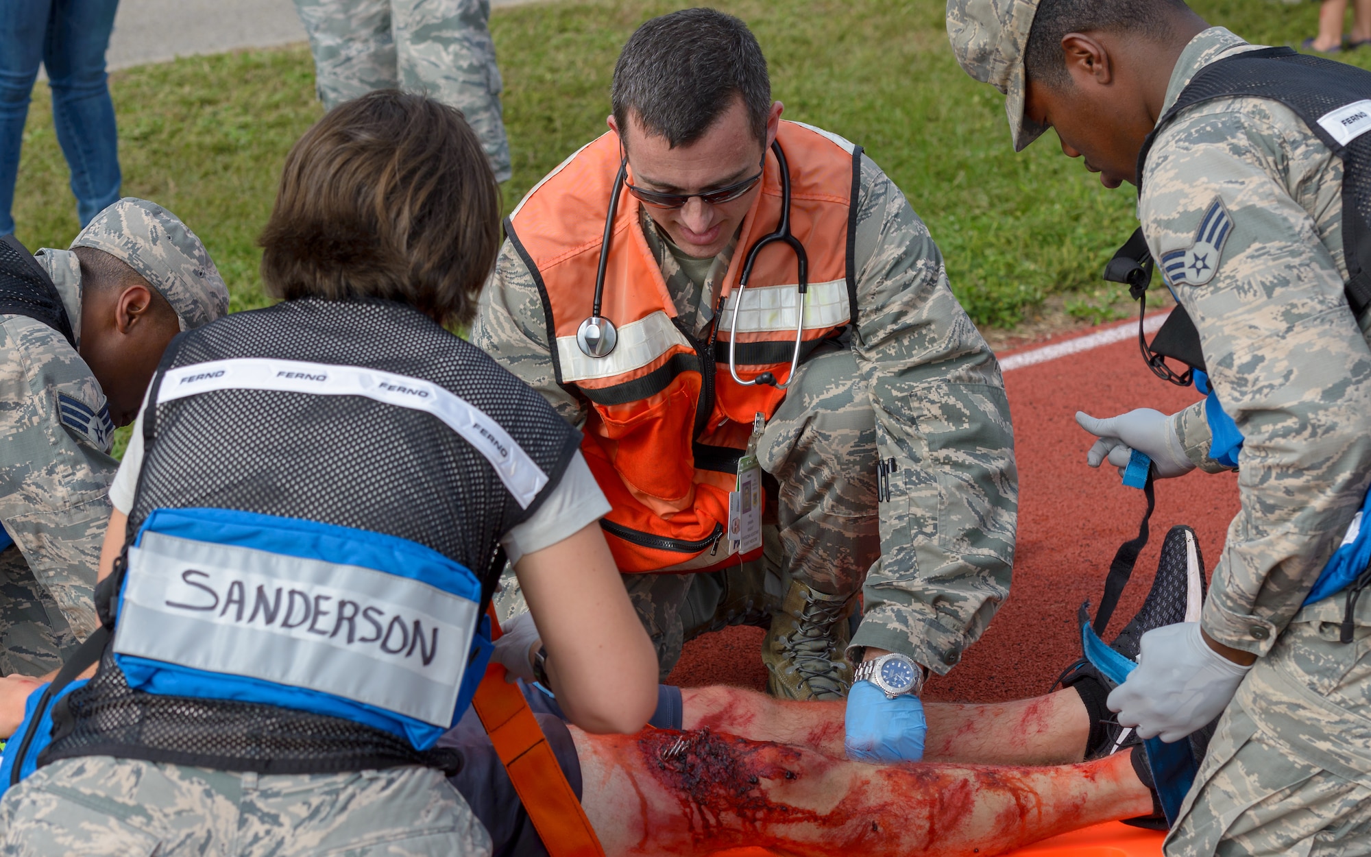 Members of the 81st Medical Group assess the injury of a "victim" at the triage site during the Anti-Terrorism, Force Protection Condition and Chemical, Biological, Radiological, Nuclear and high-yield Explosives training exercise at the Marina at Keesler Air Force Base, Mississippi, Oct. 17, 2018. The AT/FPCON/CBRNE exercise was conducted to evaluate the mission readiness and security of Keesler. (U.S. Air Force photo by Andre' Askew)