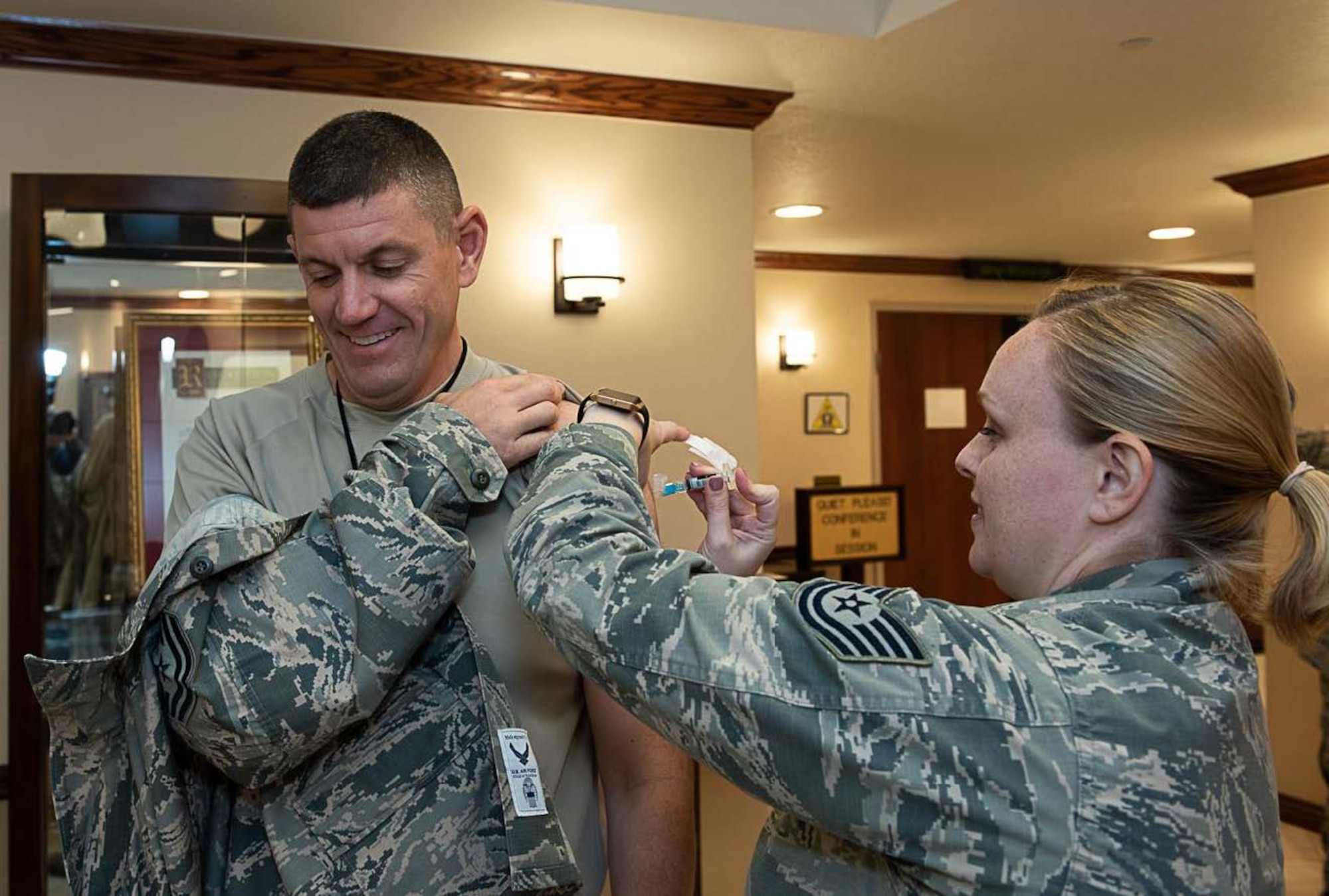 181010-F-RU983-0029 U.S. Air Force Chief Master Sgt. Derek Crowder, command chief, 60th Air Mobility Wing is administered his seasonal influenza vaccination by Tech. Sgt. Kelly Manibusan, NCO in charge of the David Grant USAF Medical Center’s Allergy/Immunology, Oct. 10, 2018, at Travis Air Force Base, Calif. ( U.S. Air Force photo by Heide Couch).