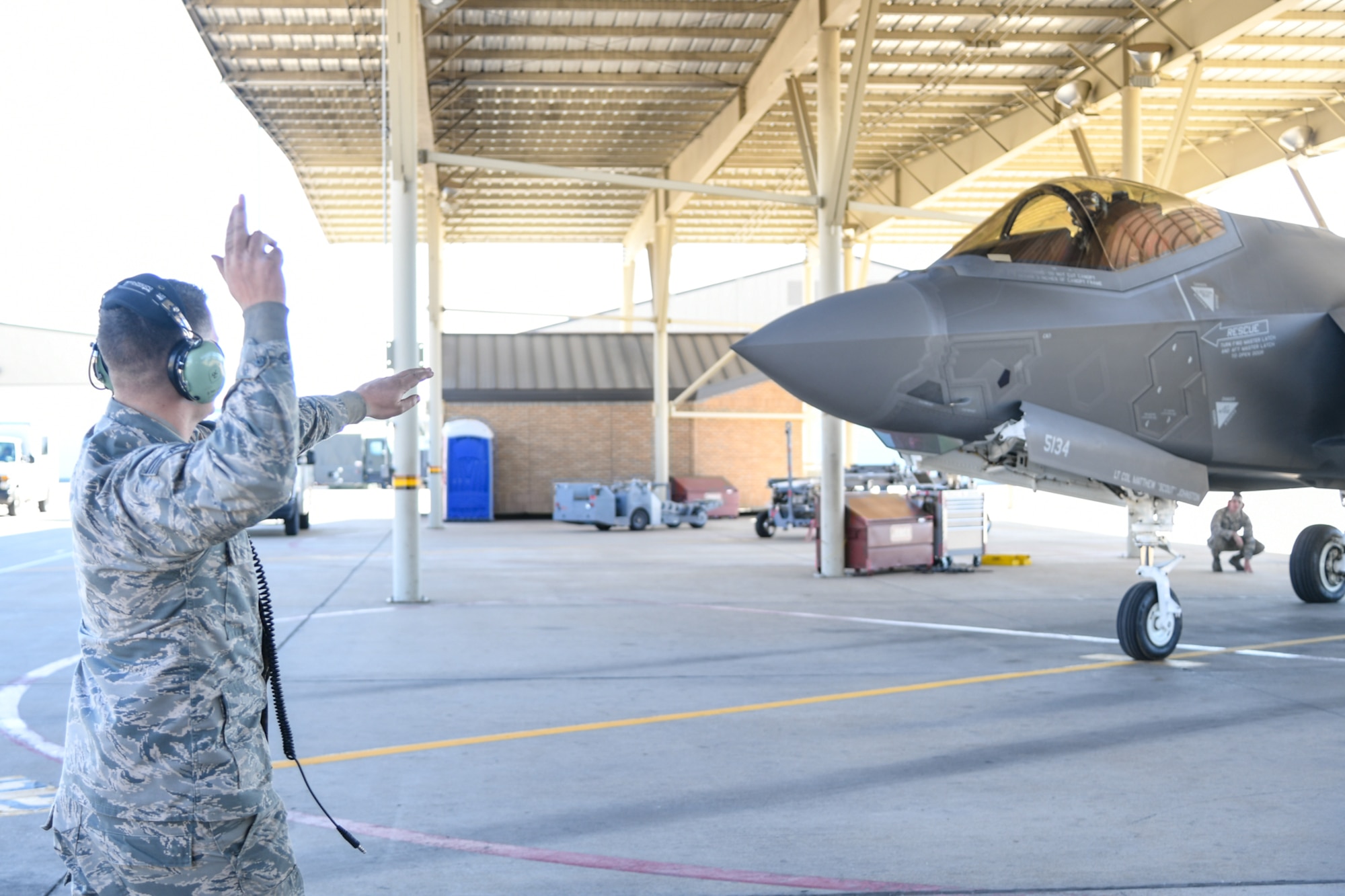 Staff Sgt. Brian Morrissey, 34th Fighter Squadron crew chief, prepares to send off an F-35A Lightning II piloted by Maj. Daniel Toftness, a reservist in the 419th Fighter Wing, Oct. 18, 2018, at Hill Air Force Base, Utah. The flight marked the 10,000th sortie with the aircraft at Hill since the first operational F-35s arrived in September 2015. (U.S. Air Force photo by Cynthia Griggs)
