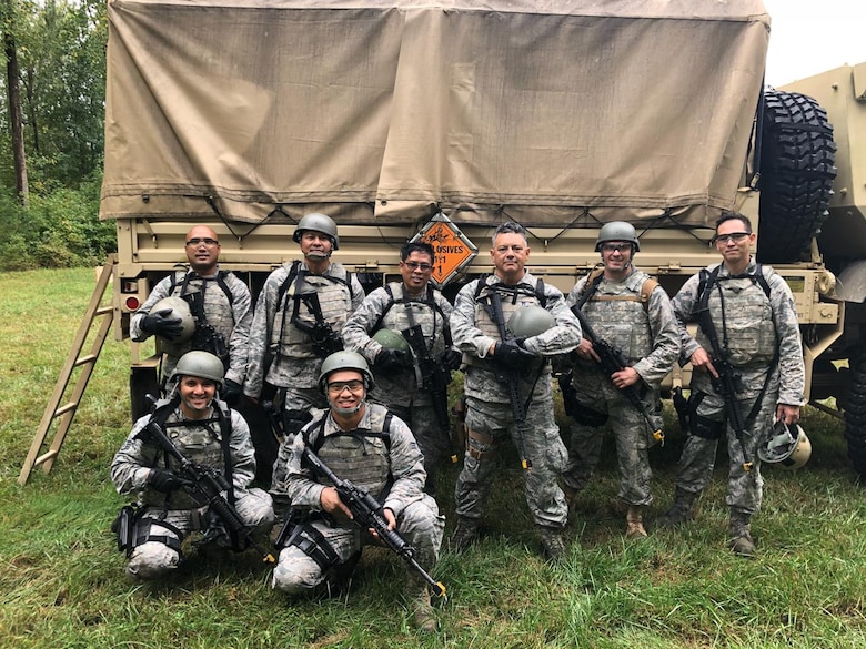 Members of the Air Force Reserve’s 44th Aerial Port Squadron based out of Andersen Air Force Base, Guam, participate in the Fieldcraft Hostile Course Sept. 17-28, 2018, at Joint Base McGuire-Dix-Lakehurst, New Jersey. Back row: Tech. Sgt. Noli Pegarido, Senior Master Sgt. Rhodel Sevilla, Master Sgt. Edgar Tiamzon, Master Sgt. Peter Martinez, Maj. Brian Eichers from the 27th APS, Minneapolis, Minn, and Tech. Sgt. Charles Hinkle. Front row: Staff Sgt. Jerome Larimer and Senior Airman Matthew Mira. Guam took home both of the end of course awards best attitude and unofficial leader. Special shout out to Tech. Sgt. Charles Hinkle and Senior Airman Mira for earning the awards. The fast-paced course provides Airmen the skills, knowledge and abilities necessary to perform in a hostile environment while allowing freedom of movement on the battlefield. The students participated in realistic and strenuous training scenarios used to teach skills in weapons firing, communications, mounted and dismounted individual and team movements, and map, compass, and GPS navigation. (Courtesy photo)
