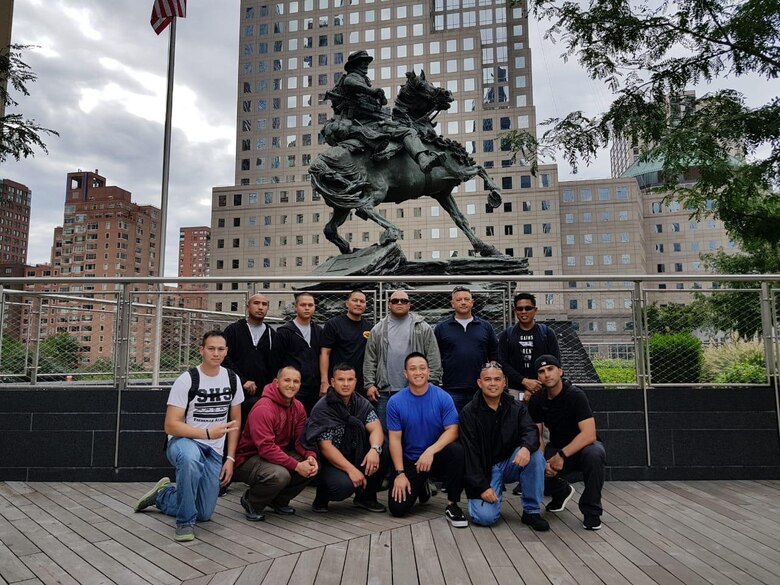 Members of the Air Force Reserve’s 44th Aerial Port Squadron based out of Andersen Air Force Base, Guam, take an opportunity to decompress from the Fieldcraft Hostile Course Sept. 17-28, 2018, at Joint Base McGuire-Dix-Lakehurst, New Jersey, and check out nearby sites, such as the De Oppresso Liber statue in Liberty Park, New York. Front row: Tech. Sgt. Charles Hinkle, Staff Sgt. Jerome Larimer, Staff Sgt. Peter Fagan, Senior Airman Matthew Mira, Tech. Sgt. Wilson Beatingo and Staff Sgt. Joshua Crisistomo. Back row: Tech. Sgt. Noli Pegarido, Senior Airman Justin Agoun, Senior Master Sgt. Rhodel Sevilla, Tech. Sgt. Phillip Blas, Master Sgt. Peter Martinez and Master Sgt. Edgar Tiamzon. The fast-paced Fieldcraft Hostile Field Course provides Airmen the skills, knowledge and abilities necessary to perform in a hostile environment while allowing freedom of movement on the battlefield. The students participated in realistic and strenuous training scenarios used to teach skills in weapons firing, communications, mounted and dismounted individual and team movements, and map, compass, and GPS navigation. (Courtesy photo)