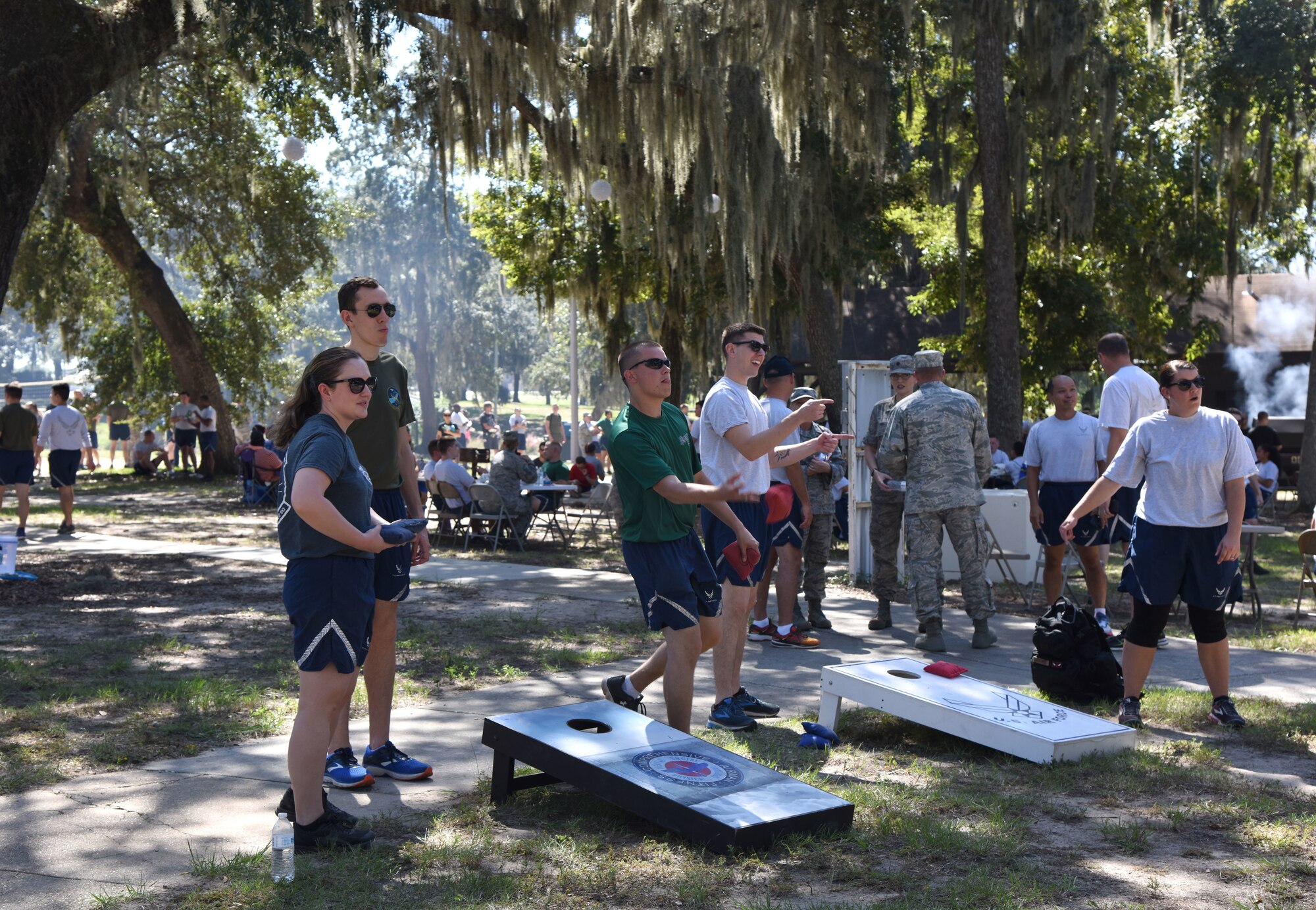 Keesler Airmen participate in a game of corn hole during Wingman Day at the Marina on Keesler Air Force Base, Mississippi, Oct. 18, 2018. Wingman Day focused on the physical domain, resiliency and team-building initiatives across the base followed by a barbeque and games at the Marina. (U.S. Air Force photo by Kemberly Groue)