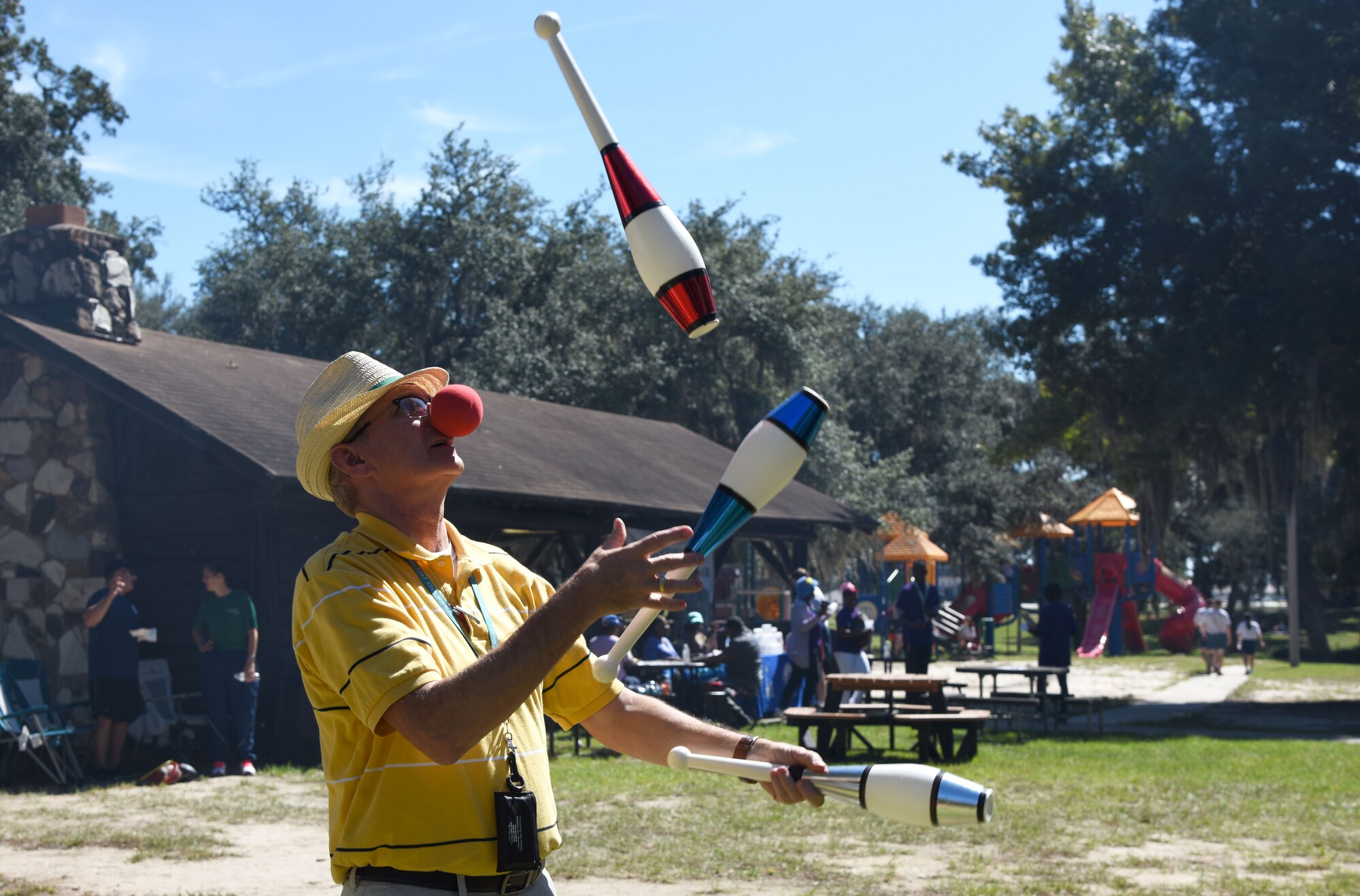 Barry Newman, 81st Training Wing sexual assault response coordinator, juggles for Keesler personnel during Wingman Day at the Marina on Keesler Air Force Base, Mississippi, Oct. 18, 2018. Wingman Day focused on the physical domain, resiliency and team-building initiatives across the base followed by a barbeque and games at the Marina. (U.S. Air Force photo by Kemberly Groue)