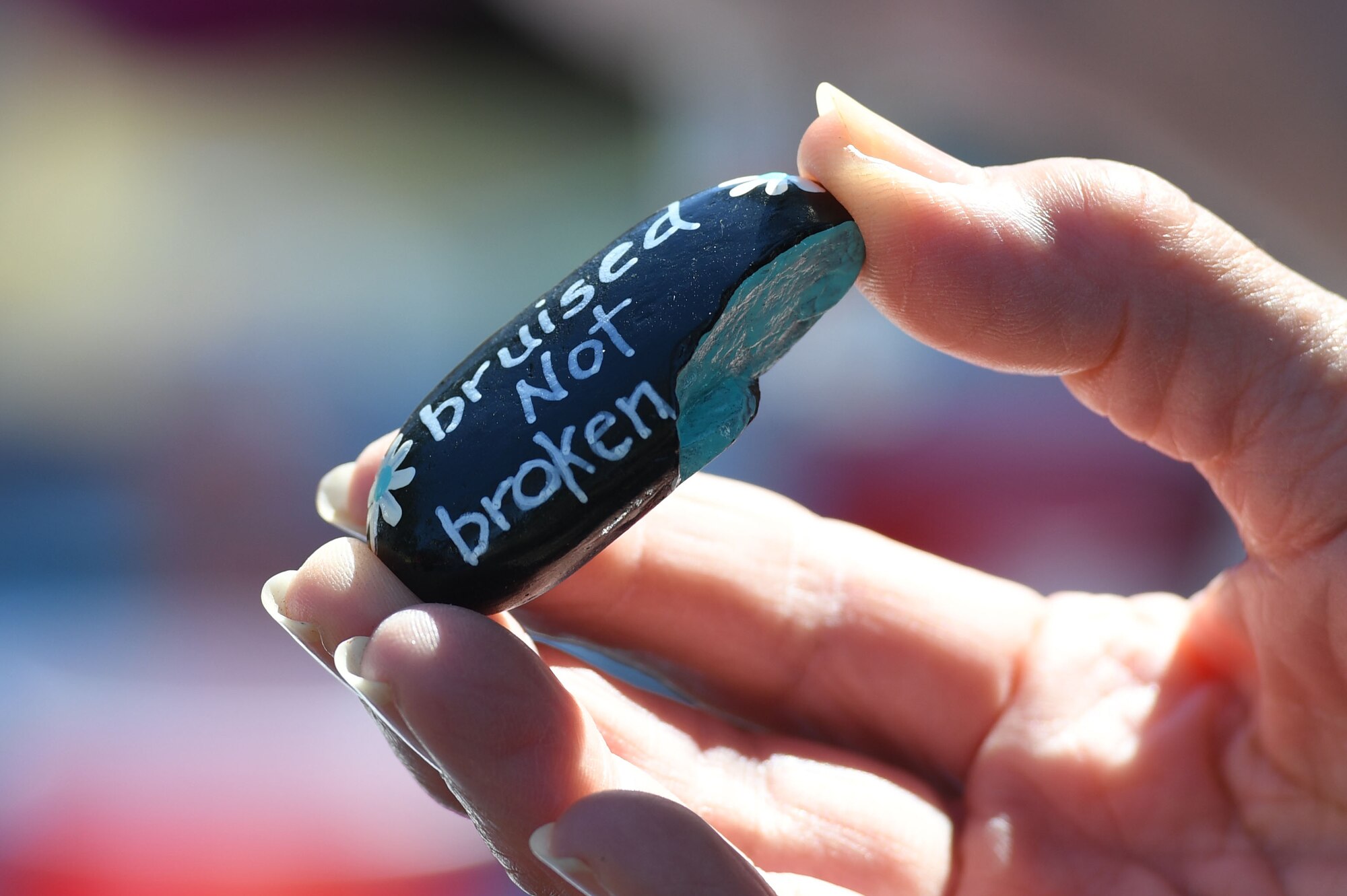 Base personnel personalize rocks for the serenity garden at the Keesler Medical Center during Wingman Day at the Marina on Keesler Air Force Base, Mississippi, Oct. 18, 2018. Wingman Day focused on the physical domain, resiliency and team-building initiatives across the base followed by a barbeque and games at the Marina. (U.S. Air Force photo by Kemberly Groue)