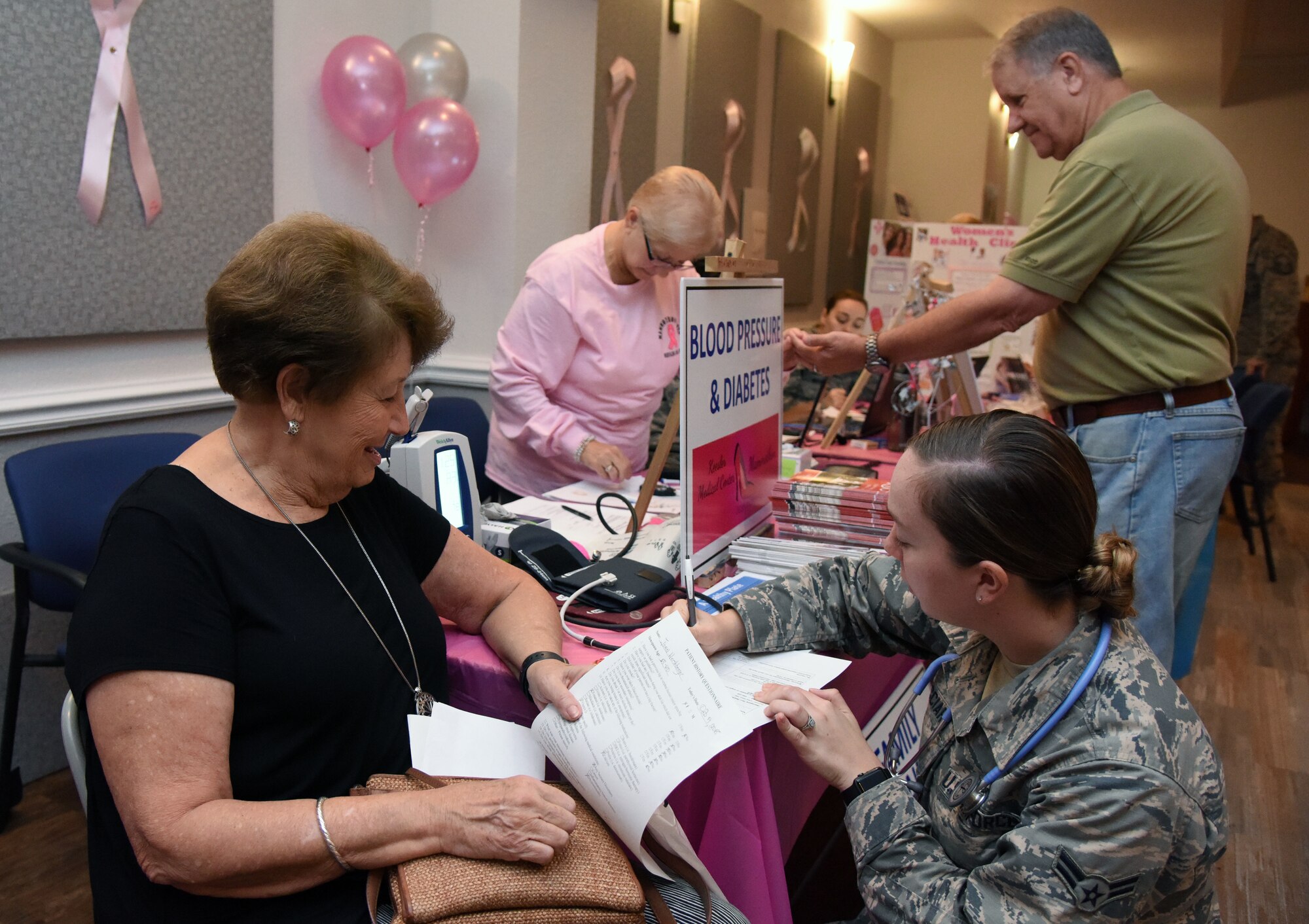 U.S. Air Force Airman 1st Class Jacquelyn Gucciardi, 81st Medical Operations Squadron medical technician, logs the blood pressure count of Joan Hershberge, spouse of retired Col. David Hershberge (deceased), during the 7th Annual Mammothon Cancer Screening and Preventative Health Fair inside the Don Wylie Auditorium on Keesler Air Force Base, Mississippi, Oct. 19, 2018. The 81st Medical Group hosted the walk-in event which included screenings for multiple types of cancer and chronic diseases in honor of Breast Cancer Awareness Month. (U.S. Air Force photo by Kemberly Groue)