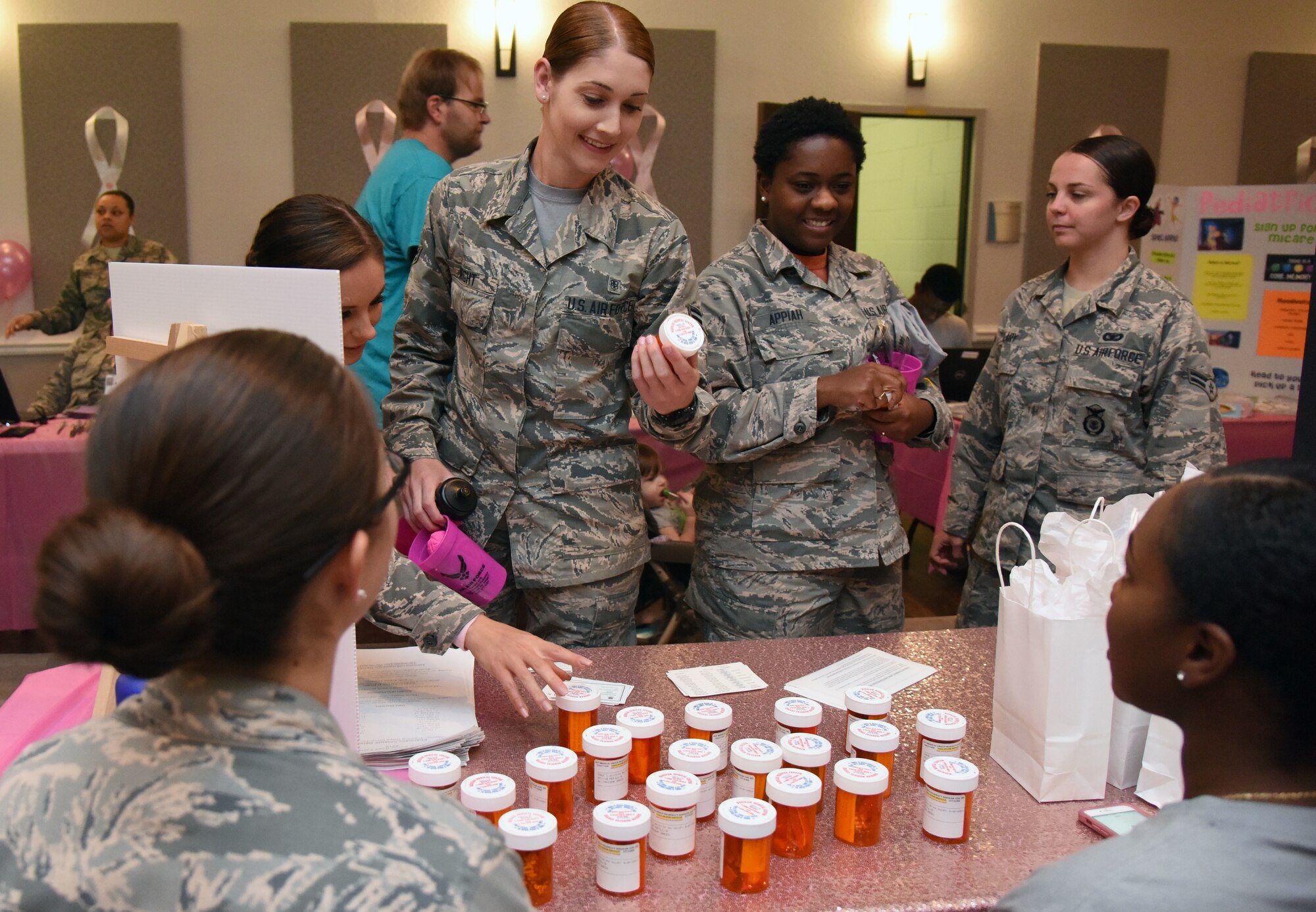 Keesler personnel observes medicine bottles filled with candy during the 7th Annual Mammothon Cancer Screening and Preventative Health Fair inside the Don Wylie Auditorium on Keesler Air Force Base, Mississippi, Oct. 19, 2018. The 81st Medical Group hosted the walk-in event which included screenings for multiple types of cancer and chronic diseases in honor of Breast Cancer Awareness Month. (U.S. Air Force photo by Kemberly Groue)