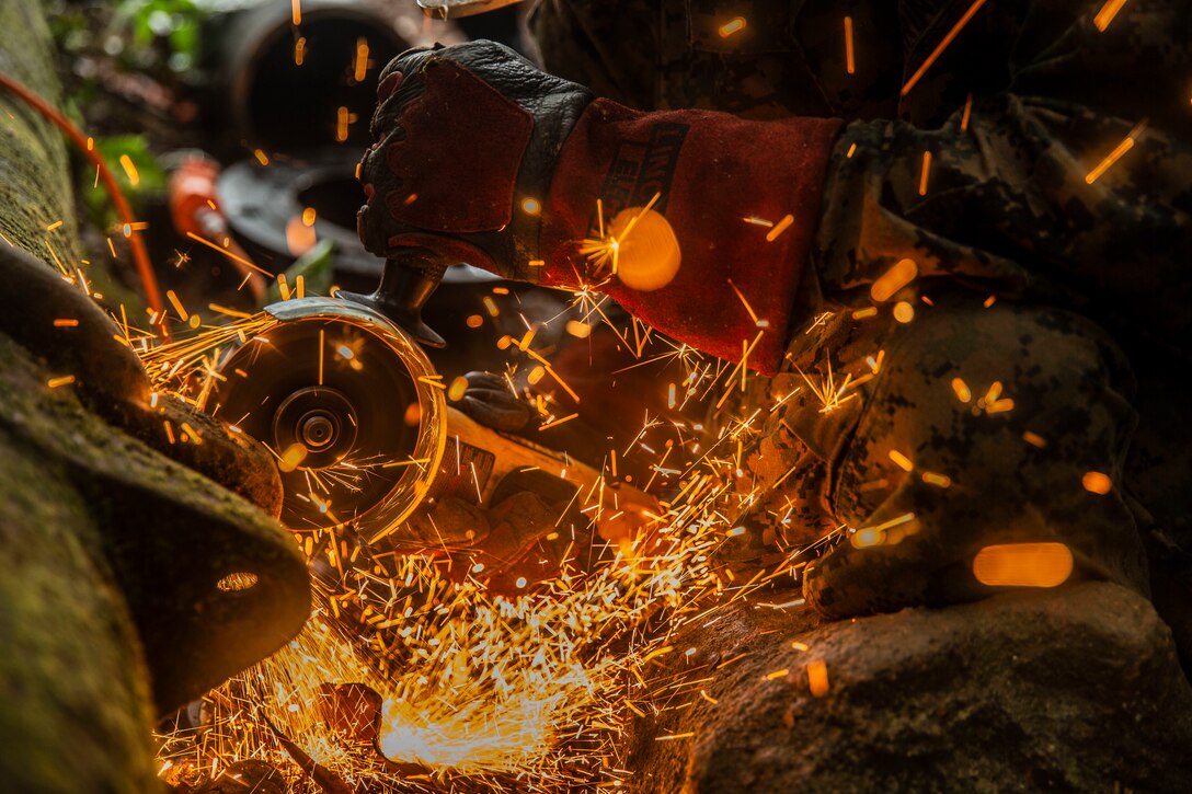 U.S. Marine Staff Sgt. Immanuel Garcia, a metal worker with Special Purpose Marine Air-Ground Task Force – Southern Command begins cutting sections of a broken water pipe on Sep 19, 2018 in Trujillo, Honduras. The water valve was stuck at 80% shut-off effecting 6 local communities containing roughly 8,000 people. The Marines repaired the pipe to return water to the local communities. The Marines and sailors of SPMAGTF-SC are conducting security cooperation training and engineering projects alongside partner nation military forces in Central and South America. The unit is also on standby to provide humanitarian assistance and disaster relief in the event of a hurricane or other emergency in the region.