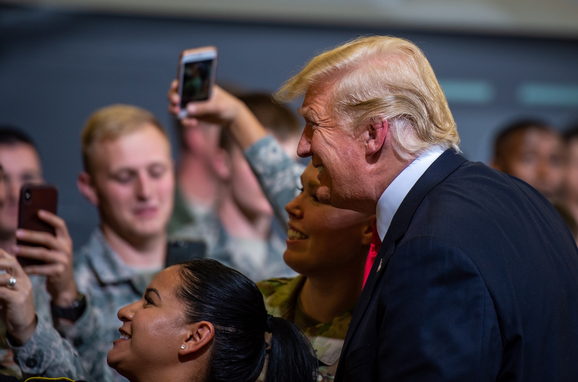 President Donald J. Trump poses for a photo with Airmen during his visit to Luke Air Force Base, Ariz., Oct. 19, 2018. Trump acknowledged and emphasized the importance of Arizona’s military presence, including Luke’s role in building the future of airpower. (U.S. Air Force photo by Senior Airman Alexander Cook)