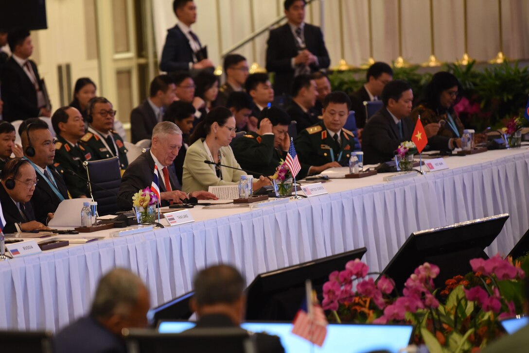 Defense Secretary James N. Mattis sits at a table with other defense ministers during a meeting.