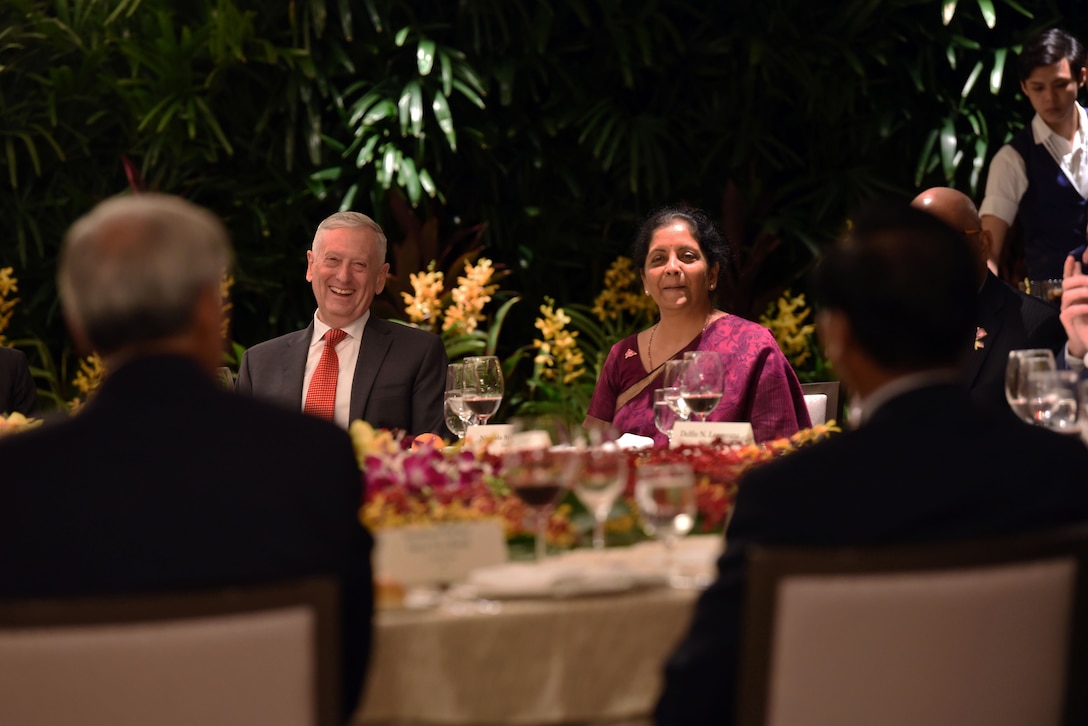U.S. Defense Secretary James N. Mattis sits next to  Indian Defense Minister Nirmala Sitharaman at a table during a leaders' lunch.