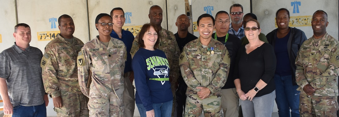 In a small gathering of friends and team mates of the Afghanistan District, John S. Solomon proudly and humbly displays his recent medals he was awarded upon serving the district in his capacity as a contracting officer.