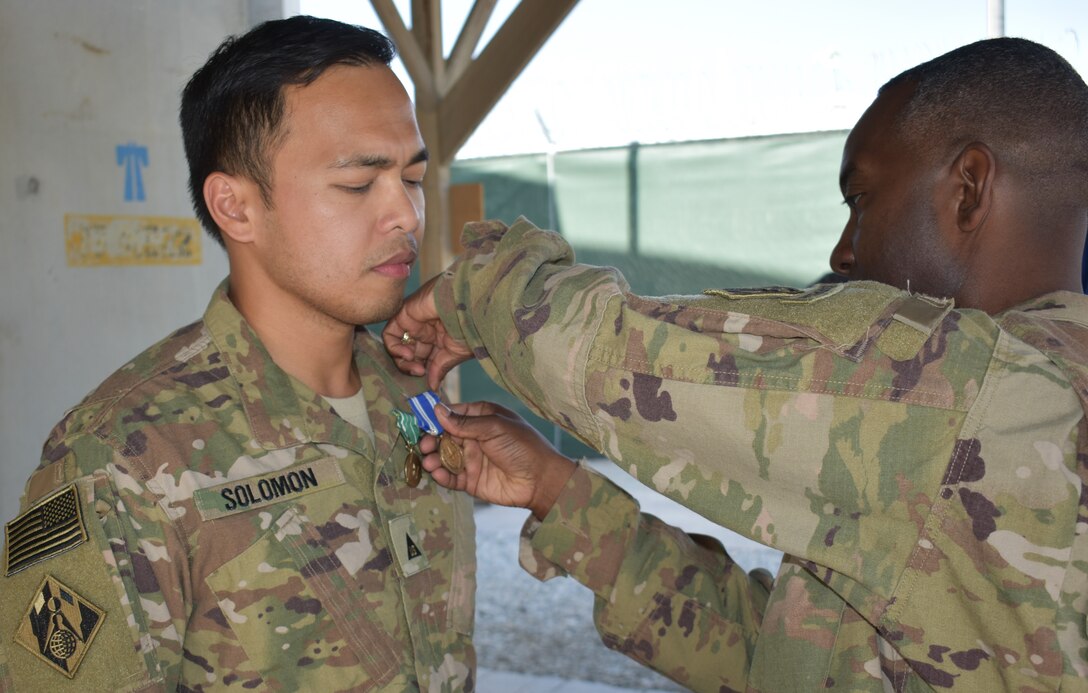 John S. Solomon, Seattle District, deployed in Support of Operation Freedom’s Sentinel and Resolute Support Mission in Bagram Airfield, Afghanistan receives the NATO Medal and the Commander’s Award for Civilian Service from Afghanistan District Commander, Jason Kelly.