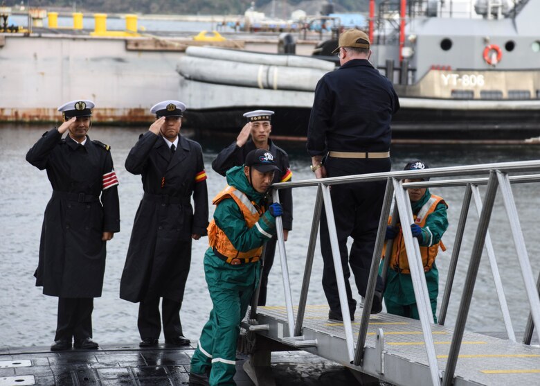 FLEET ACTIVITIES YOKOSUKA, Japan (Oct. 19, 2018) Rear Adm. Jimmy Pitts, Commander, Submarine Group 7, salutes Japan Maritime Self-Defense Force Sailors as he is whistled aboard JS Seiryu (SS-509), prior to going underway aboard the Japanese submarine. The familiarity cruise is to reinforce the submarine group's commitment to the U.S.-Japan alliance.