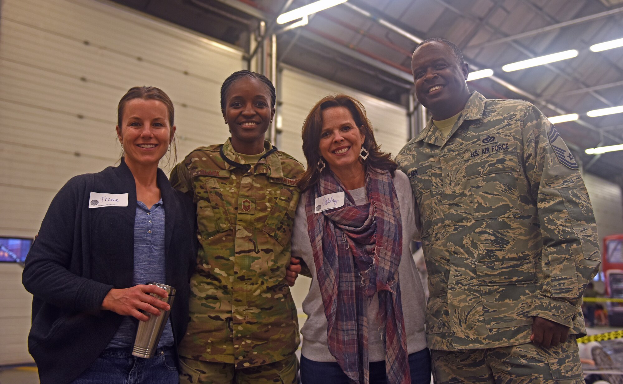 Trina Bentley, wife of 100th Air Refueling Wing Vice Commander Cassius Bentley, U.S. Air Force Senior Master Sgt. Afryea Clark, 352nd Special Operations Wing Exercise Superintendent, Cathy Amrhein, wife of 100th ARW Commander Christopher Amrhein, and U.S. Air Force Chief Master Sgt. Daniel Clark, 100th Civil Engineering Squadron chief enlisted manager, pose for a photo during a Hearts Apart event Oct. 18, 2018, on RAF Mildenhall, England. The 100th Civil Engineering Squadron hosted the monthly event, which helps brings Team Mildenhall families of deployed Airmen closer during times of separation. (U.S. Air Force photo by Airman 1st Class Brandon Esau)