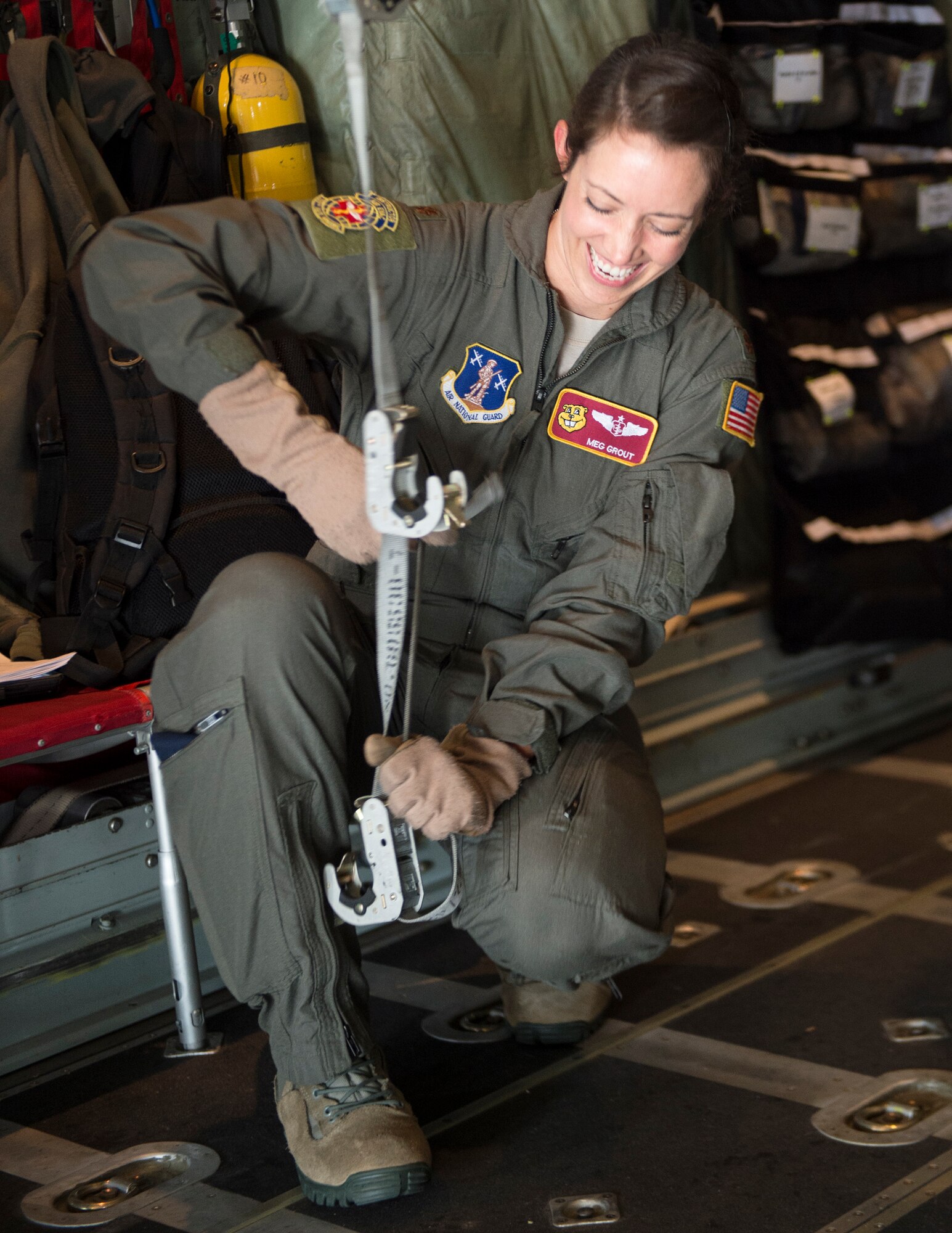U.S. Air Force Maj. Meghan Grout, 109th Aeromedical Evacuation Squadron, prepares the cargo bay of a C-130 Hercules for litters in St. Paul, Minn., Oct. 9, 2018.