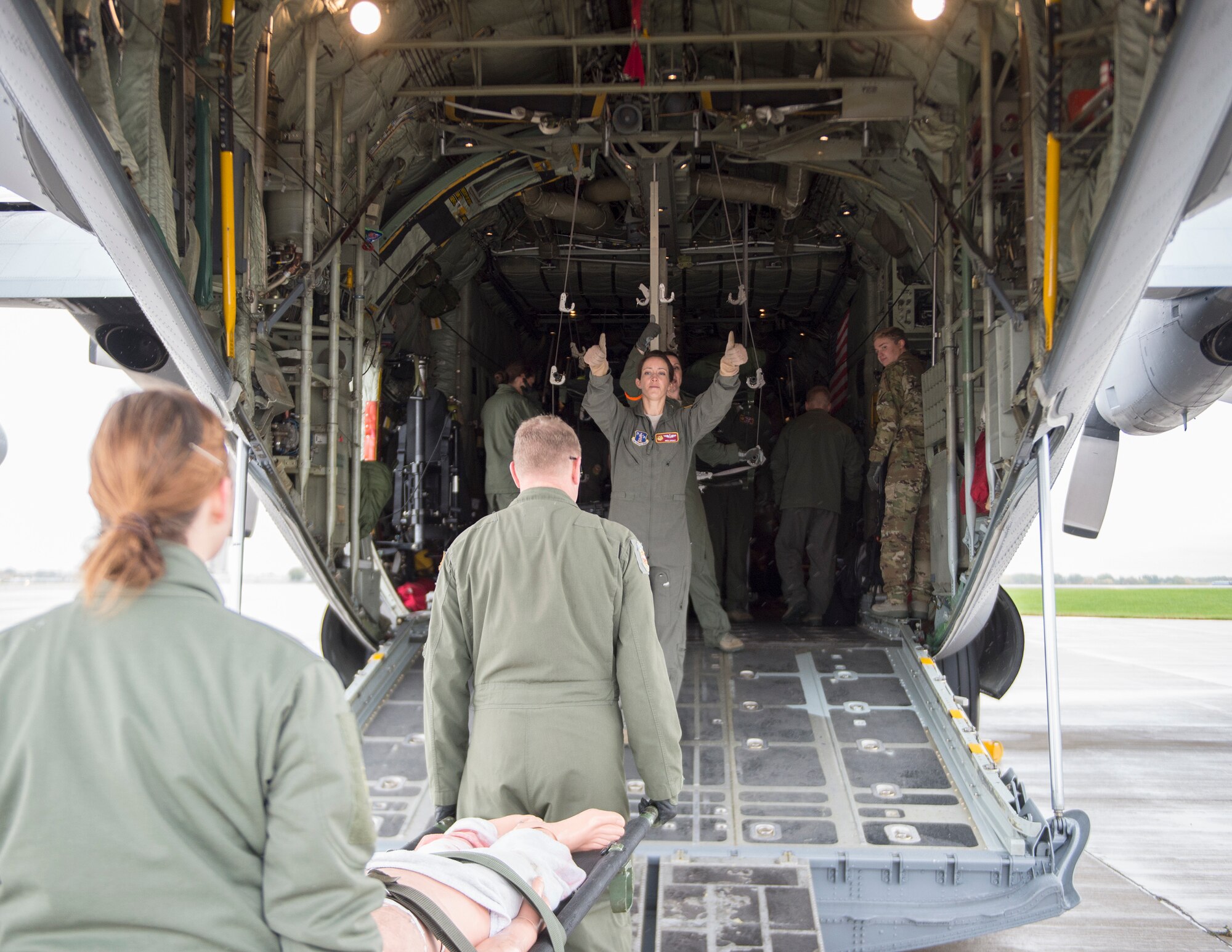 U.S. Air Force Maj. Meghan Grout, 109th Aeromedical Evacuation Squadron, gives directions on loading a C-130 Hercules in St. Paul, Minn., Oct. 9, 2018.