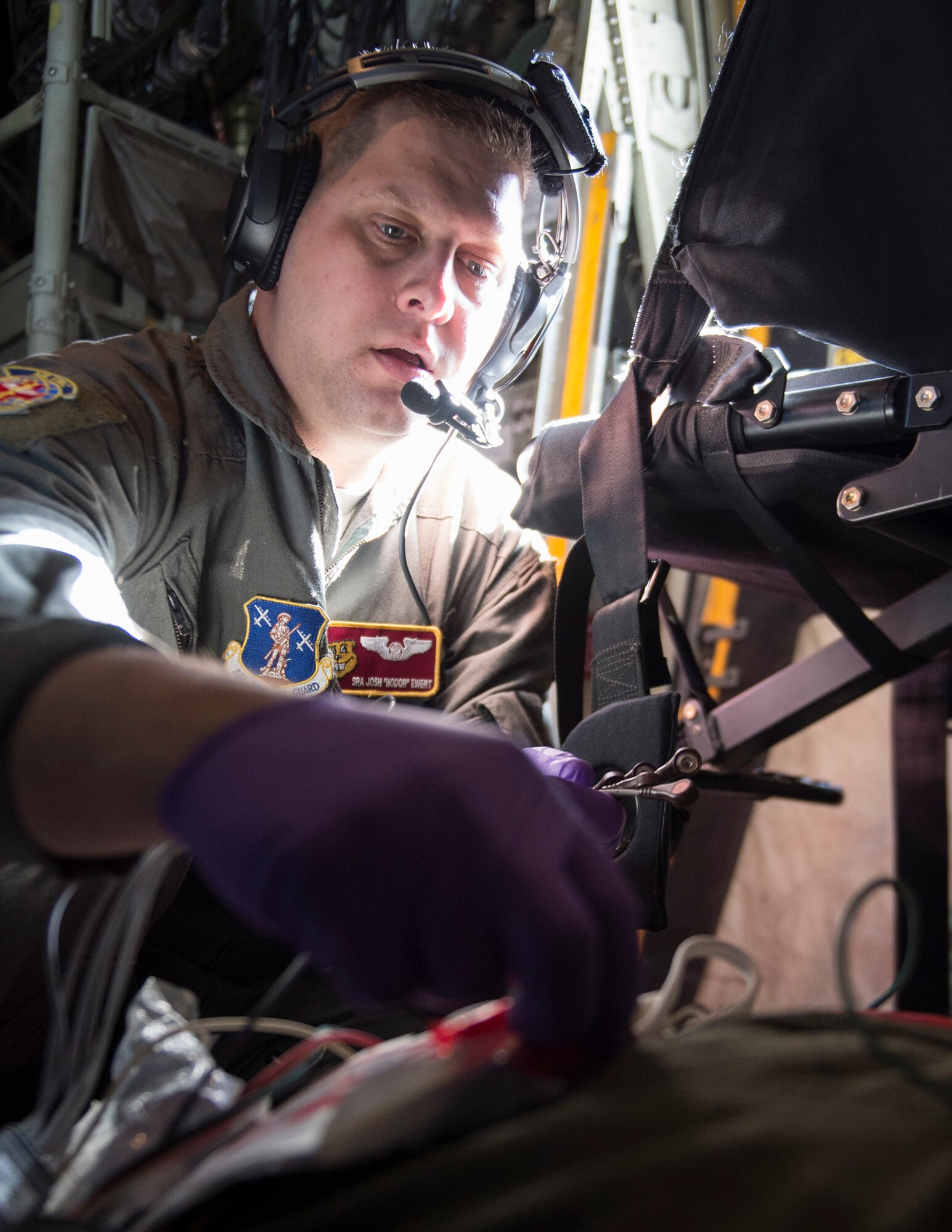 U.S. Air Force Senior Airman Joshua Ewert, 109th Aeromedical Evacuation Squadron, simulates placing a defibrillator monitor onto a role-player during a training flight in Minn., Oct. 9, 2018.