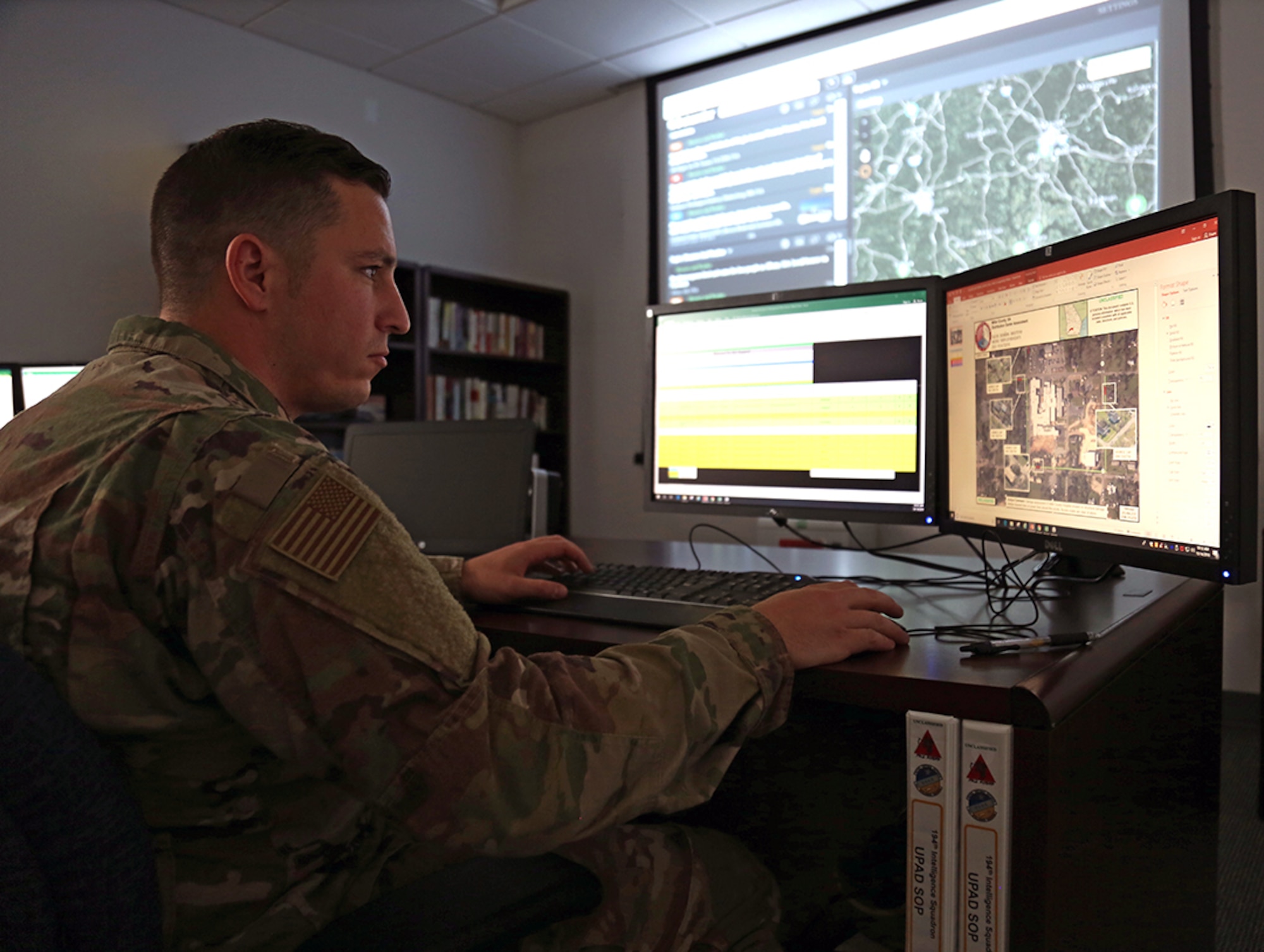 Senior Airman Jeffrey Andrews, a geospatial targeting analyst with the 194th Intelligence Squadron assigned to the Washington Air National Guard, looks at imagery of a Federal Emergency Management Agency (FEMA) distribution center Oct. 14, 2018 at Camp Murray, Wash.
