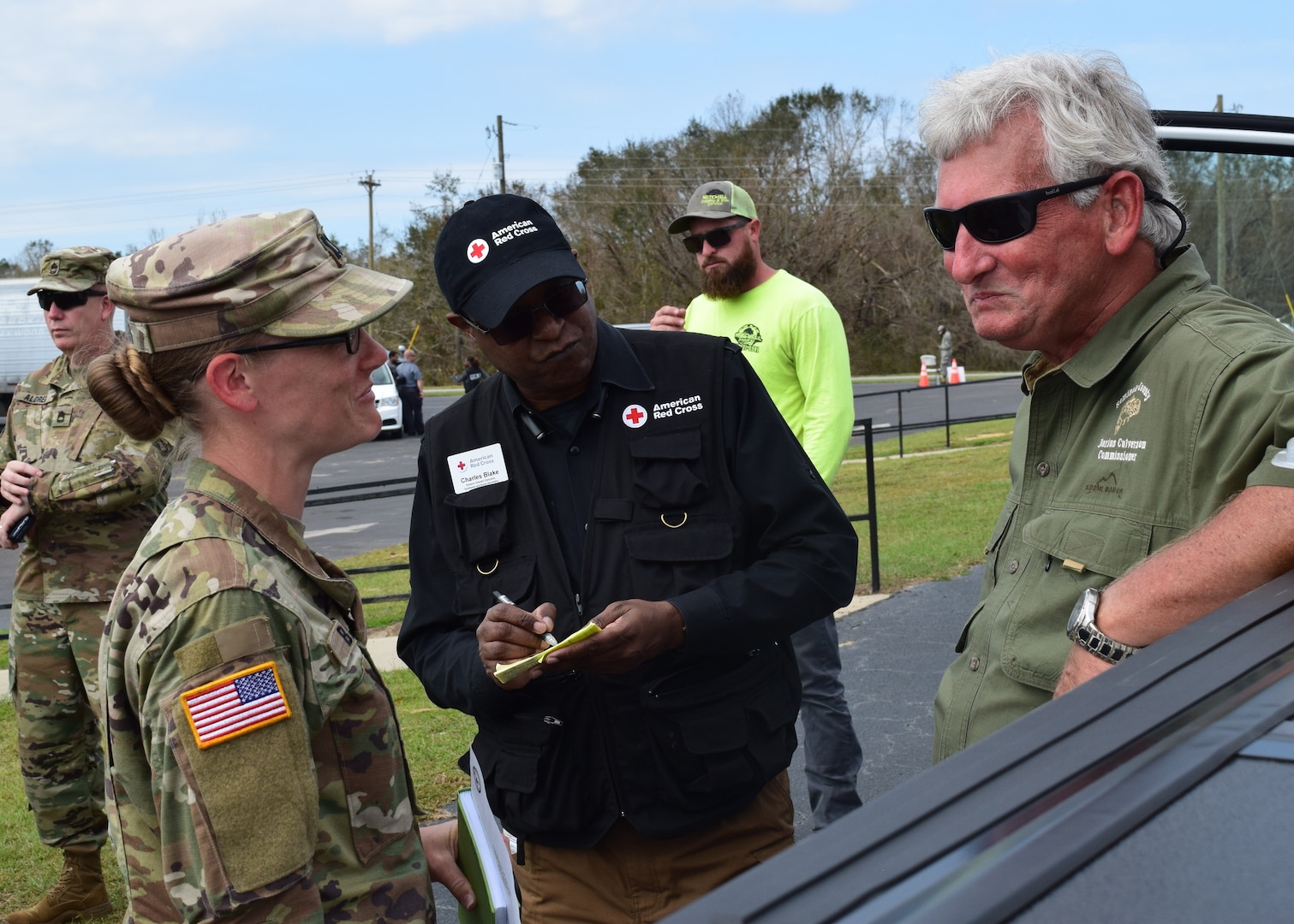 Captain Sha-Raya Bates, commander of the Washington, Ga.-based 214th Forward Support Company discusses operations at a point of distribution in Seminole County with County Commissioner Darius Culverson.