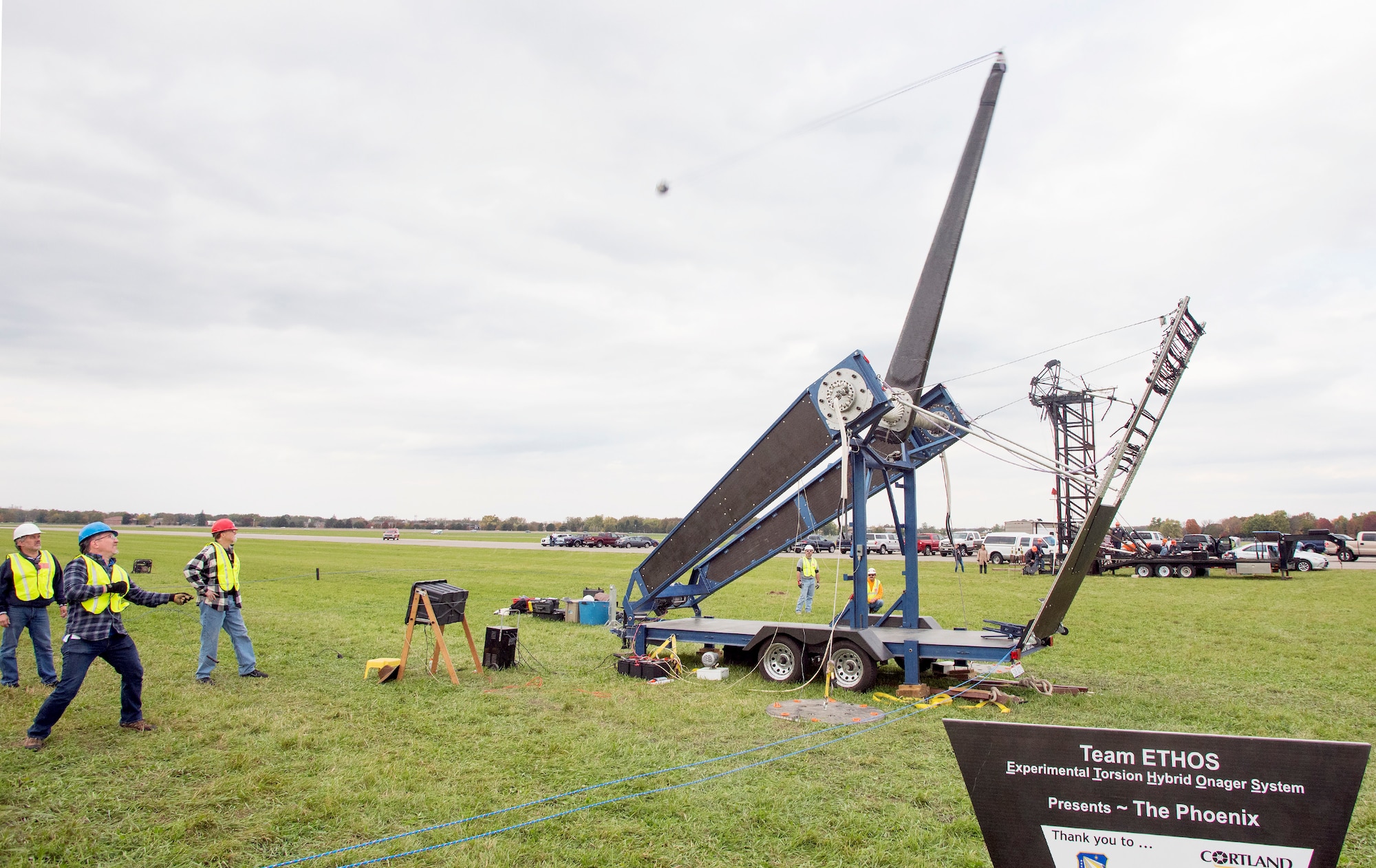 David Mollenhauer, in blue hardhat, Team ETHOS team captain, pulls the trigger of The Phoenix launching a 10-pound pumpkin downrange at the end of the 13th annual Wright-Patterson Air Force Base, Ohio, Pumpkin Chuck, Oct. 27, 2017.