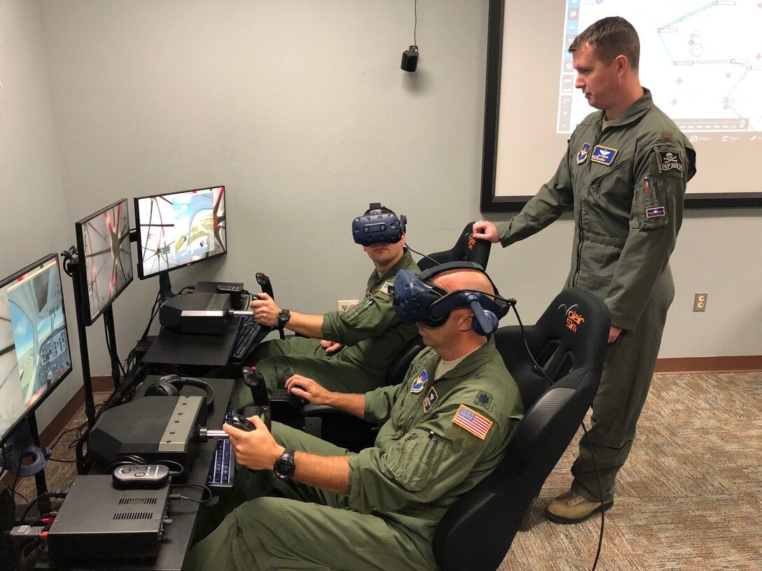 Lt. Col. Derek McCafferty (left) and Maj. Erik Jones, 99th Flying Training Squadron instructor pilots, prepare for a virtual flying training sortie Oct. 9, 2018, at Joint Base San Antonio-Randolph, Texas. The 99th FTS, along with the 560th FTS, have integrated virtual reality simulators into the pilot instructor training syllabus as part of an overall strategic effort to leverage emerging technology across the training enterprise.