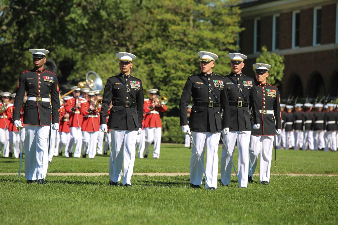 Marines with the Marine Barracks Washington D.C. parade marching staff execute “eyes right” during a parade for retired U.S. Marine Corps Sgt. Maj. John L. Canley, the 298th Marine Medal of Honor recipient at the Barracks, Oct. 19, 2017. It is tradition for the Barracks to host a parade for Marines who are awarded the Medal of Honor, our nation’s highest and most prestigious personal military decoration. (U.S. Marine Corps photo by Cpl. Damon Mclean/Released)