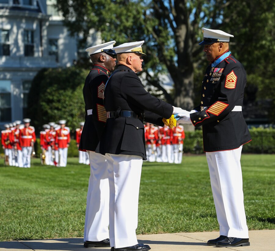 Commandant of the Marine Corps, Gen. Robert B. Neller, left, presents the Medal of Honor Flag to retired U.S. Marine Corps Sgt. Maj. John L. Canley, the 298th Marine Medal of Honor recipient, during a parade for Canley at Marine Barracks Washington D.C., Oct. 19, 2017. It is tradition for the Barracks to host a parade for Marines who are awarded the Medal of Honor, our nation’s highest and most prestigious personal military decoration.  (U.S. Marine Corps photo by Sgt. Robert Knapp/Released)