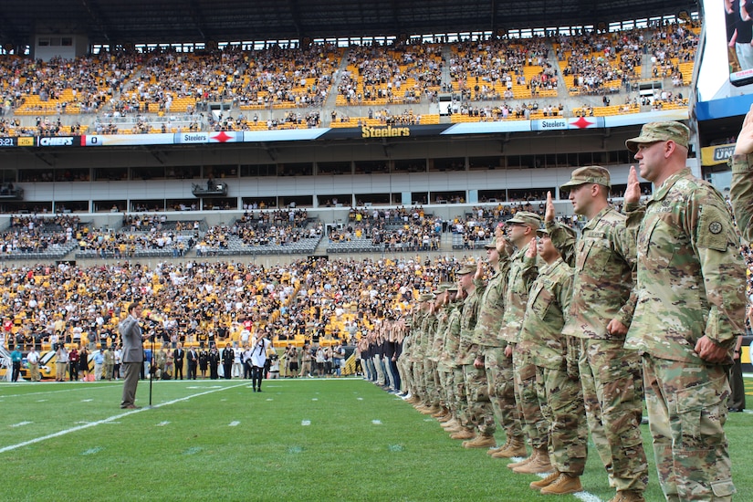 SECARMY gives the Oath at mass enlistment ceremony at Steelers game