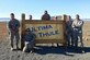 THULE AIR BASE, Greenland – Capt. Stephen Caple (second from right), 821st Support Squadron Civil Engineer flight commander, stands with his civil engineer flight next to a sign at Thule Air Base, Greenland. Caple has a team of six Airmen responsible for Air Force engineering operations as contracting officers’ representatives providing oversight to approximately 220 contractors. (Courtesy photo)