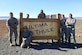 THULE AIR BASE, Greenland – Capt. Stephen Caple (second from right), 821st Support Squadron Civil Engineer flight commander, stands with his civil engineer flight next to a sign at Thule Air Base, Greenland. Caple has a team of six Airmen responsible for Air Force engineering operations as contracting officers’ representatives providing oversight to approximately 220 contractors. (Courtesy photo)