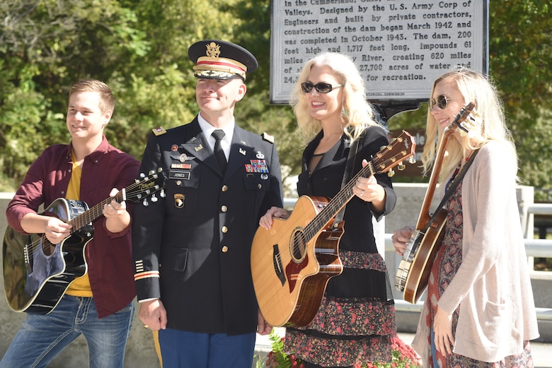 Lt. Col. Cullen Jones, U.S. Army Corps of Engineers Nashville District commander, poses with Banjoist Brandy Miller (Right), Recording Artist Delnora Reed Acuff and Guitarist Joe Dean in front of the Tennessee Historical Marker recognizing the significance of Dale Hollow Dam and Powerhouse, and Reservoir. The musicians performed music of the period of the 1940s during the 75th Anniversary Commemoration of Dale Hollow Dam and Reservoir Oct. 19, 2018. (USACE photo by Lee Roberts)